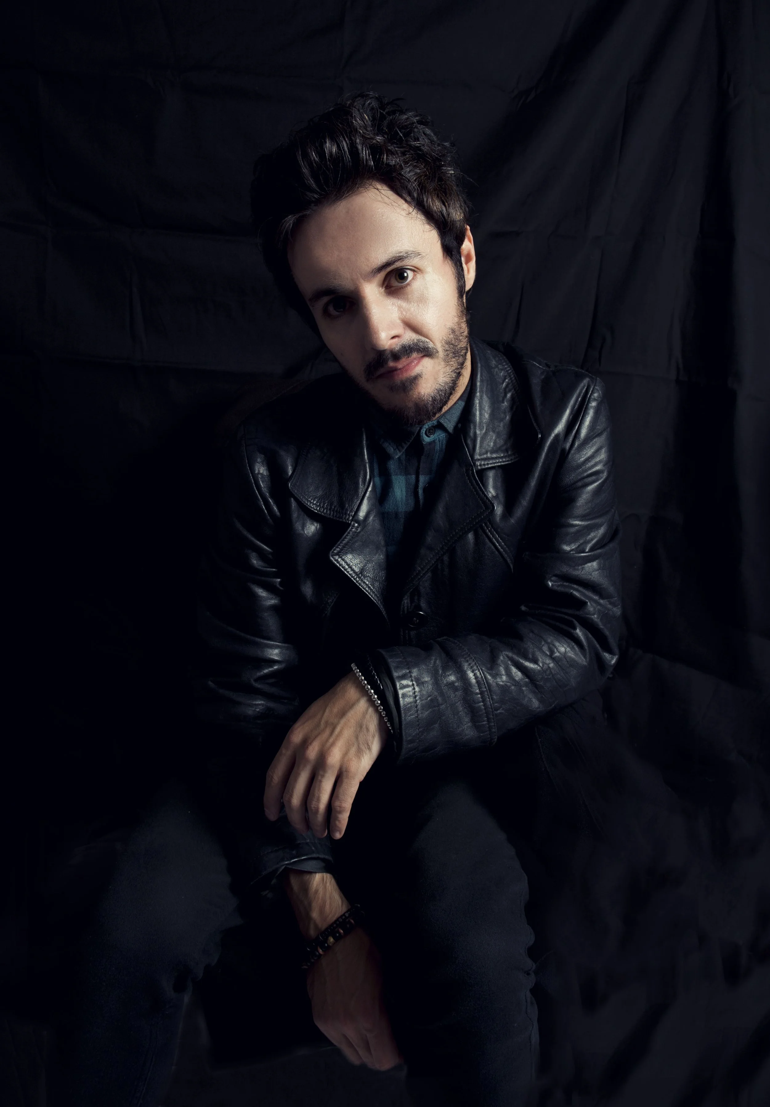 James Kennedy, the singer and author from Wales, posing in a leather jacket