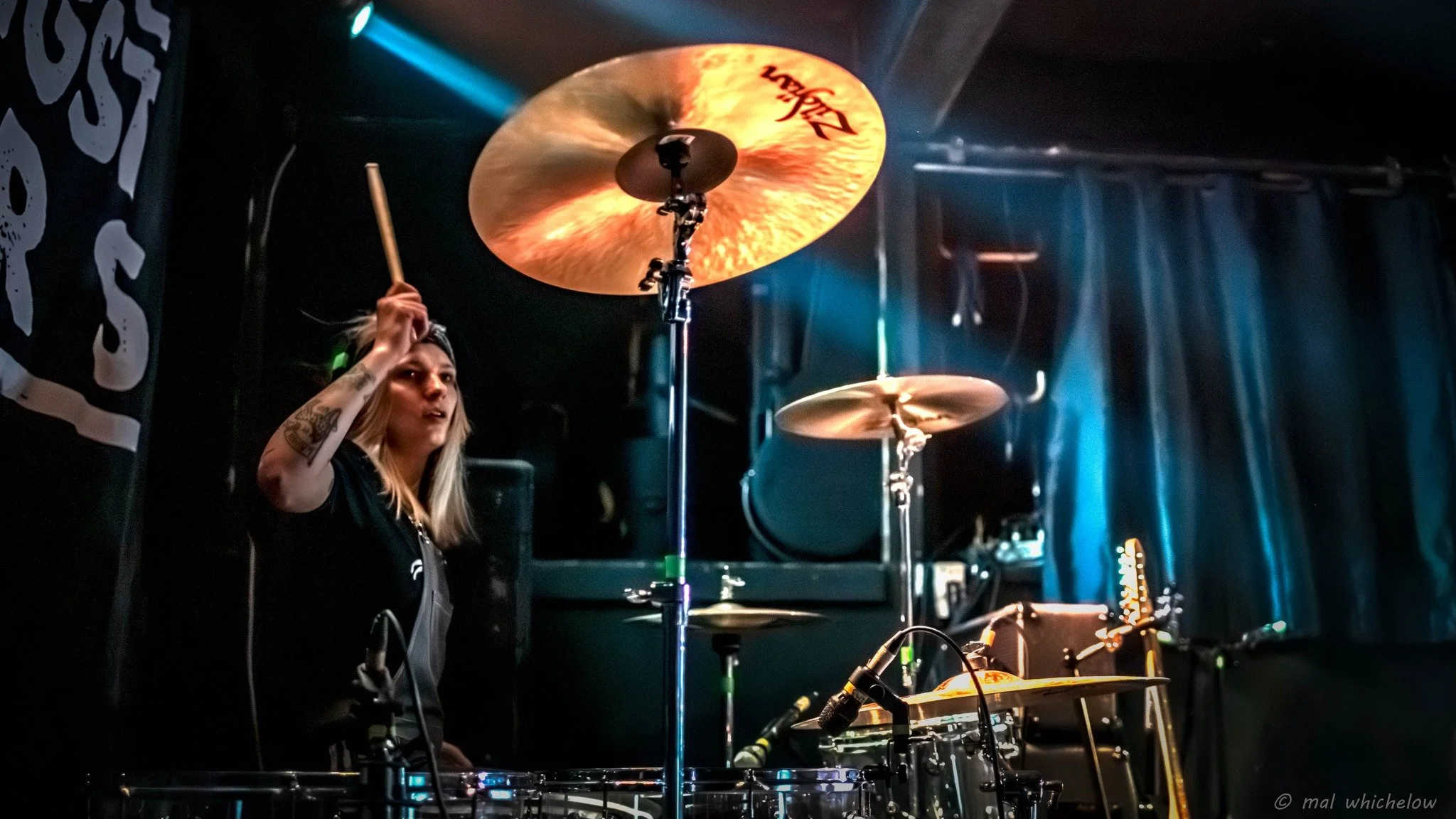 Aggy Nowicka, the female drummer with the Welsh punk rock band 'James Kennedy and The Underdogs' playing her drums on stage during a live concert 