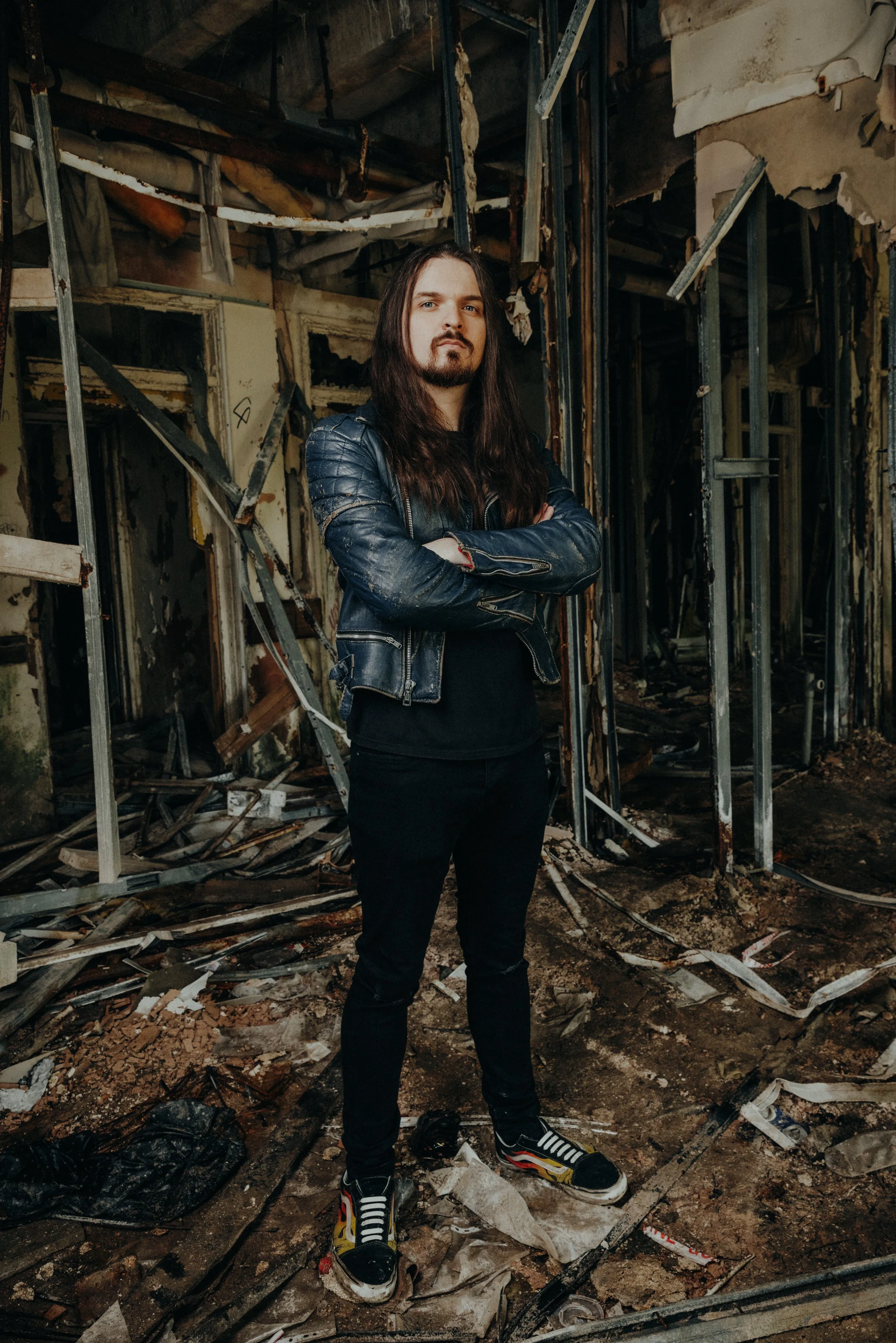 Jack Davies, the guitarist with the Welsh hard rock band 'James Kennedy and The Underdogs' posing during a photoshoot and wearing a leather jacket 