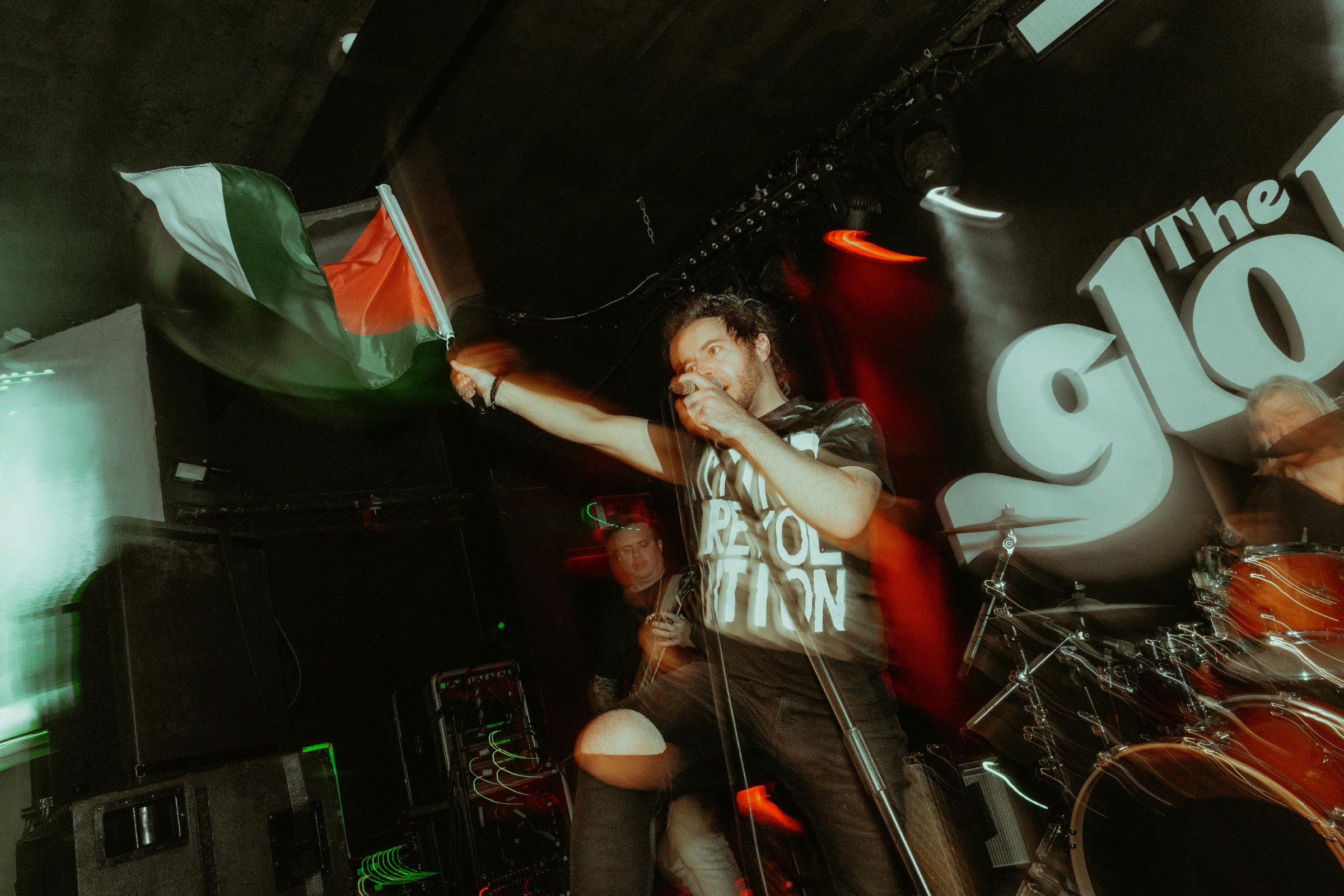 Singer James Kennedy waving a Palestinian flag on stage during a concert with his band 'James Kennedy and The Underdogs' 