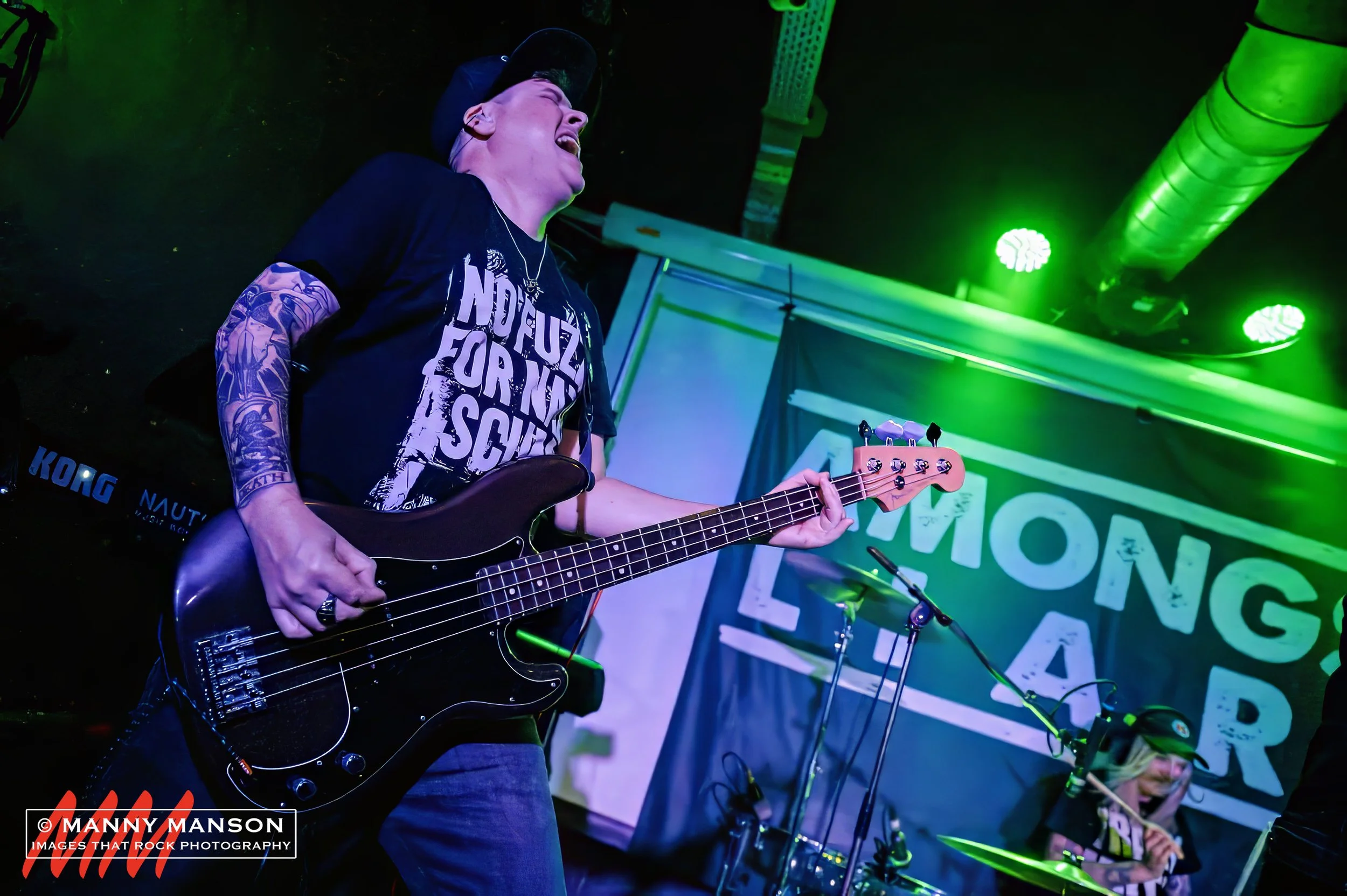 Elliot Blake, bassist in the rock band 'James Kennedy and The Underdogs' playing a concert and screaming at the sky