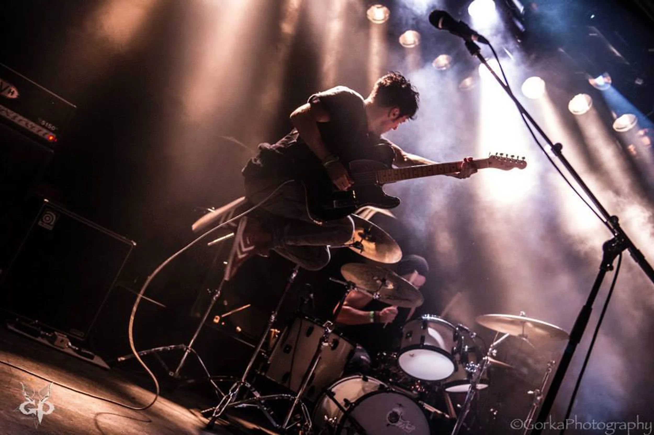 'Kyshera' band concert in Switzerland with singer, James Kennedy jumping in the air with his Fender Telecaster guitar live on stage