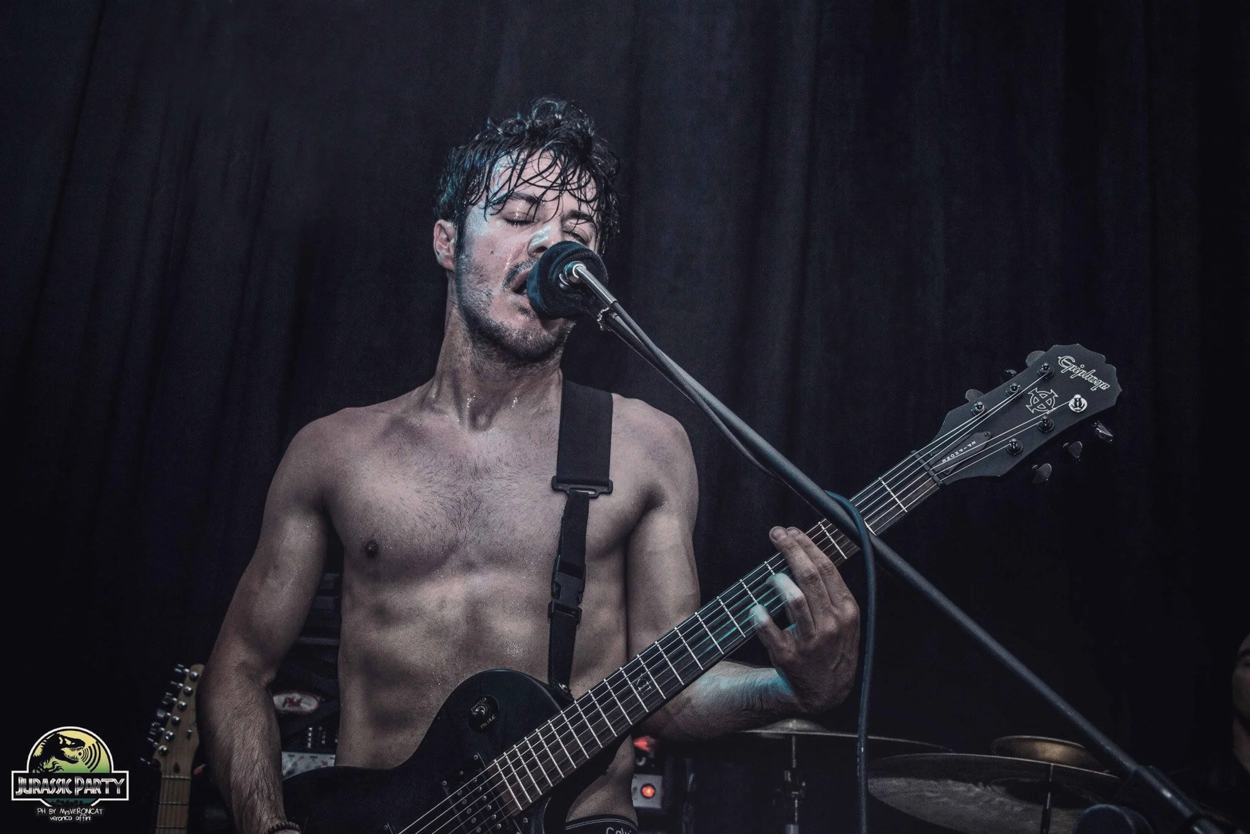 James Kennedy, the singer in the rock bands 'Kyshera' and 'James Kennedy and The Underdogs' playing guitar topless on stage in Italy 