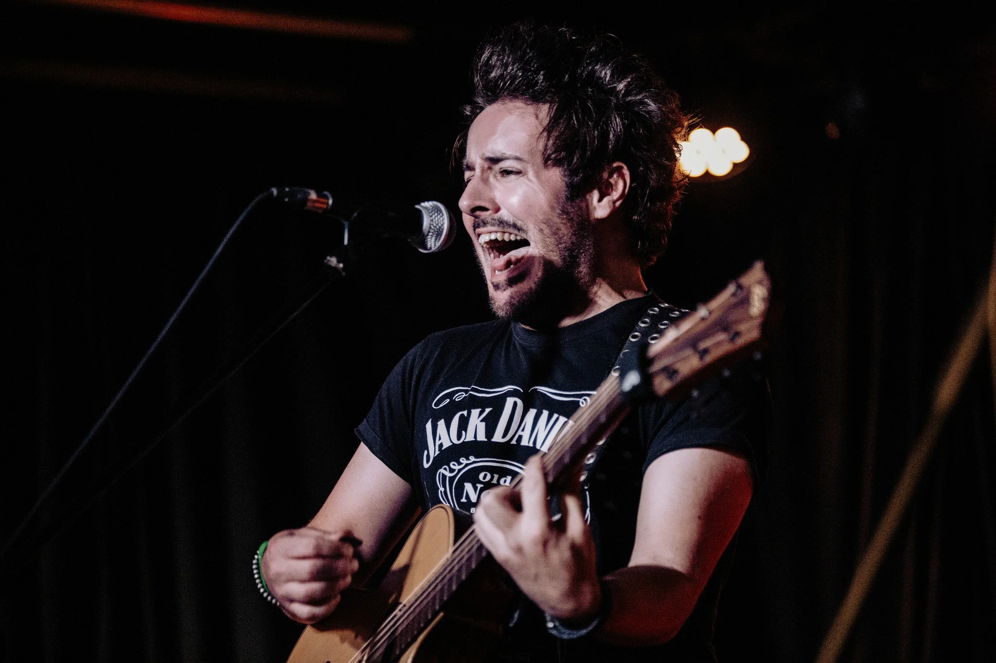 James Kennedy, the singer, author and podcaster from Wales singing and playing an acoustic guitar during a 'James Kennedy and The Underdogs' concert at Just Push Play festival 2024