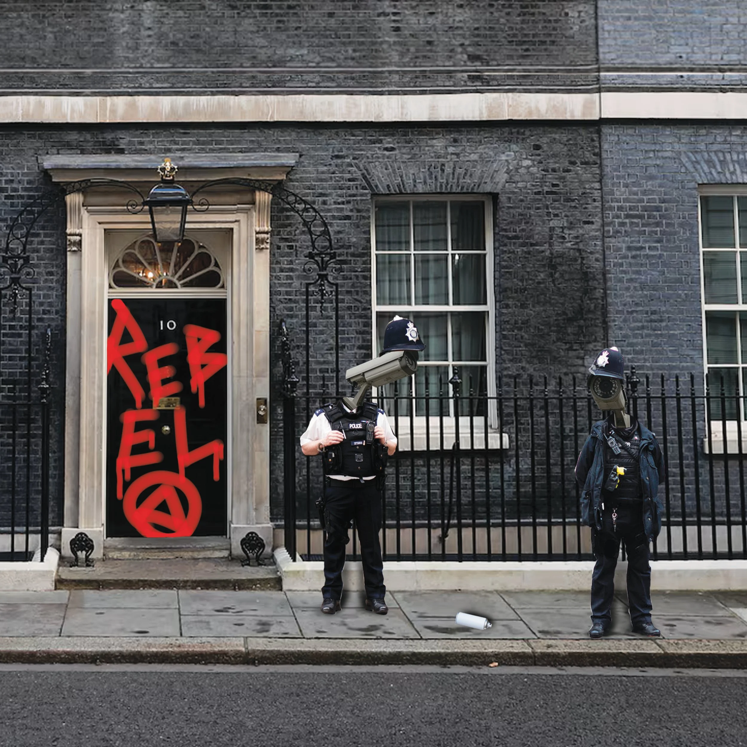 Two police officers in riot gear stand in front of a black brick building with windows, a door, and a black metal fence. There is a red 'X' and the word 'FREE' written on the door in red paint. Security cameras are mounted on the fence. A white disposable cup is on the sidewalk near the officers.