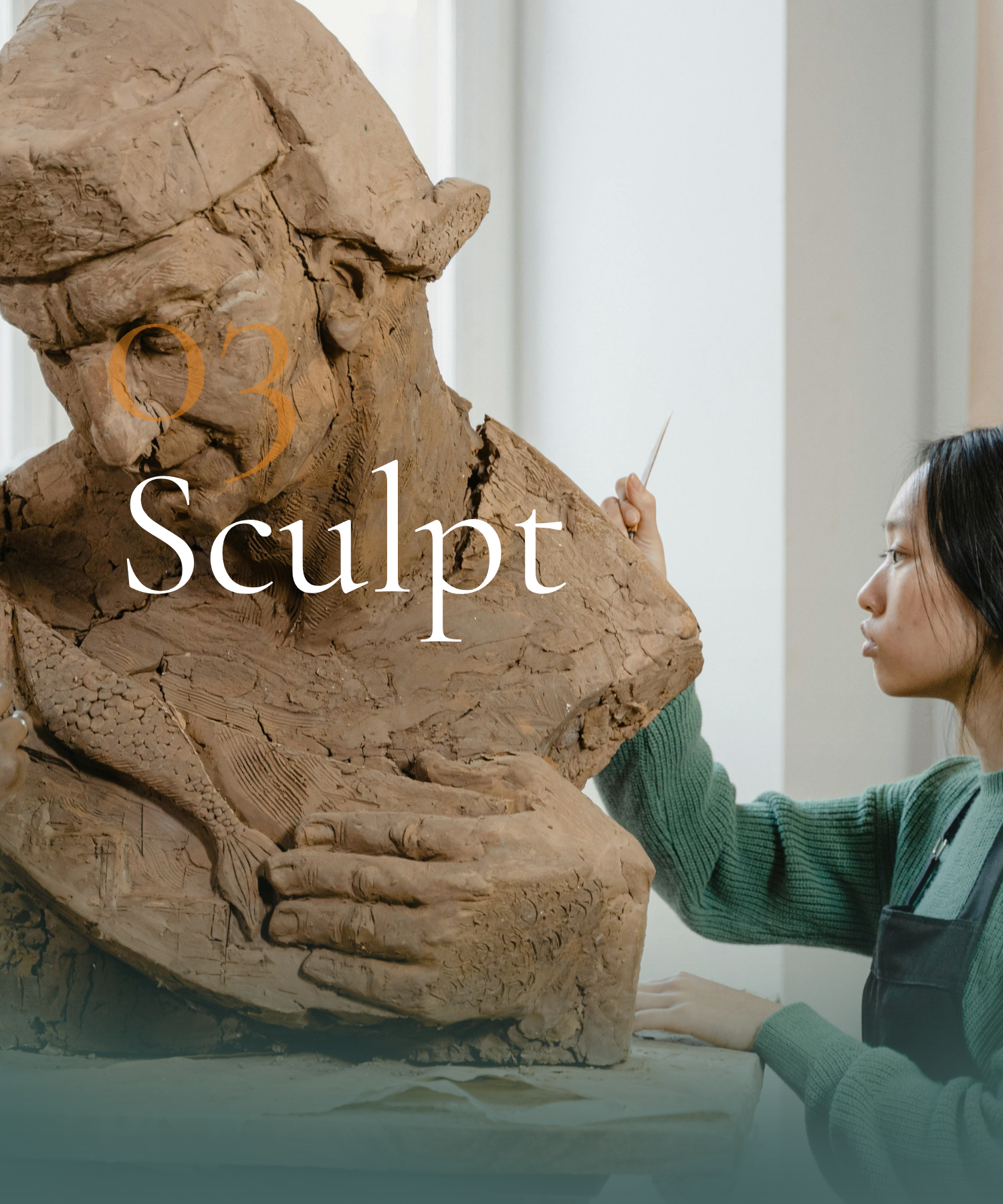 A woman sculpting a large clay sculpture of a human head and hand.