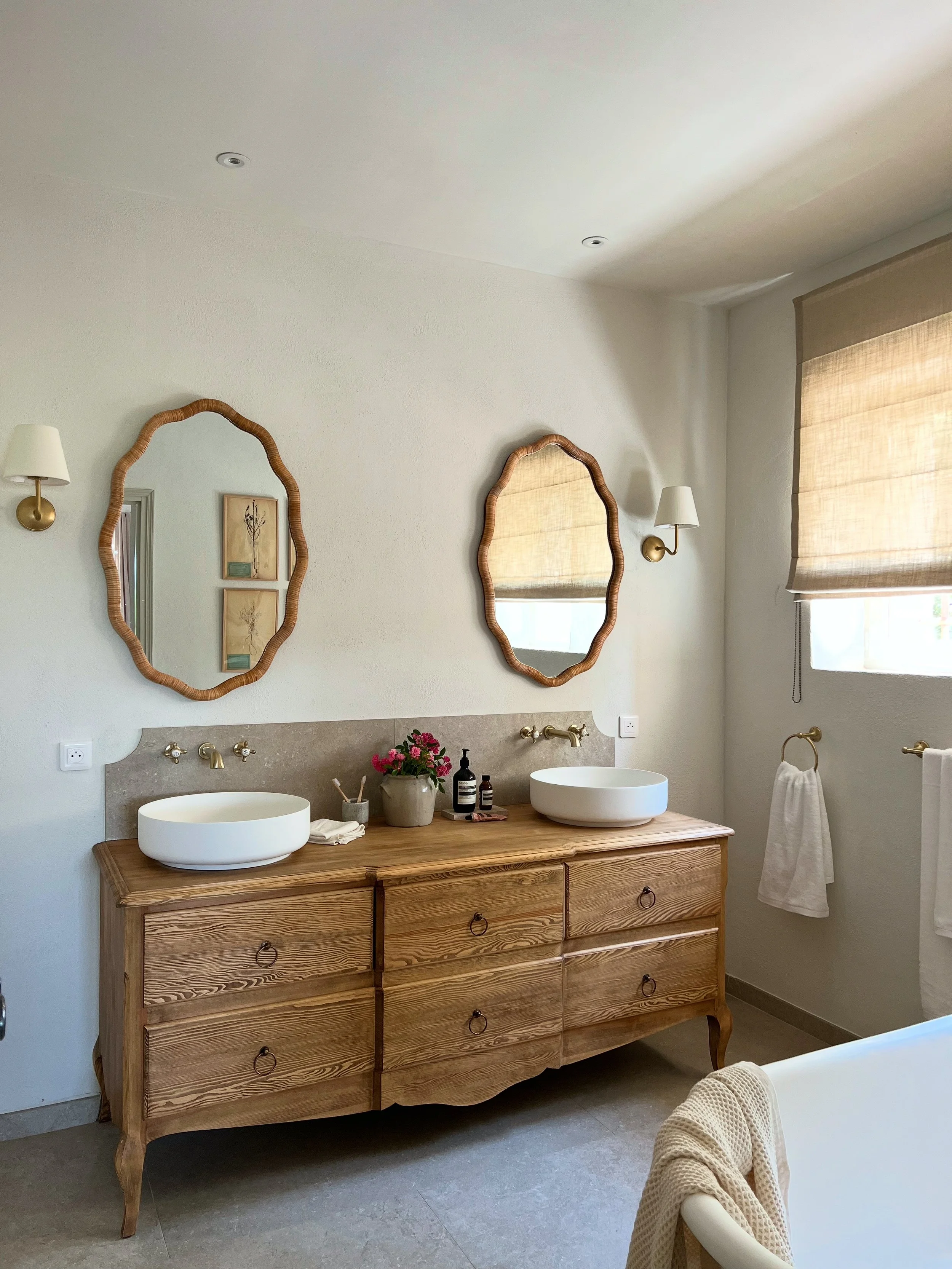 scallop mirrors, rattan mirrors, wooden vanity, timber vanity, bath tub, luxury bath, sheer linen blind, light space, corston lights, stone floor, wellness