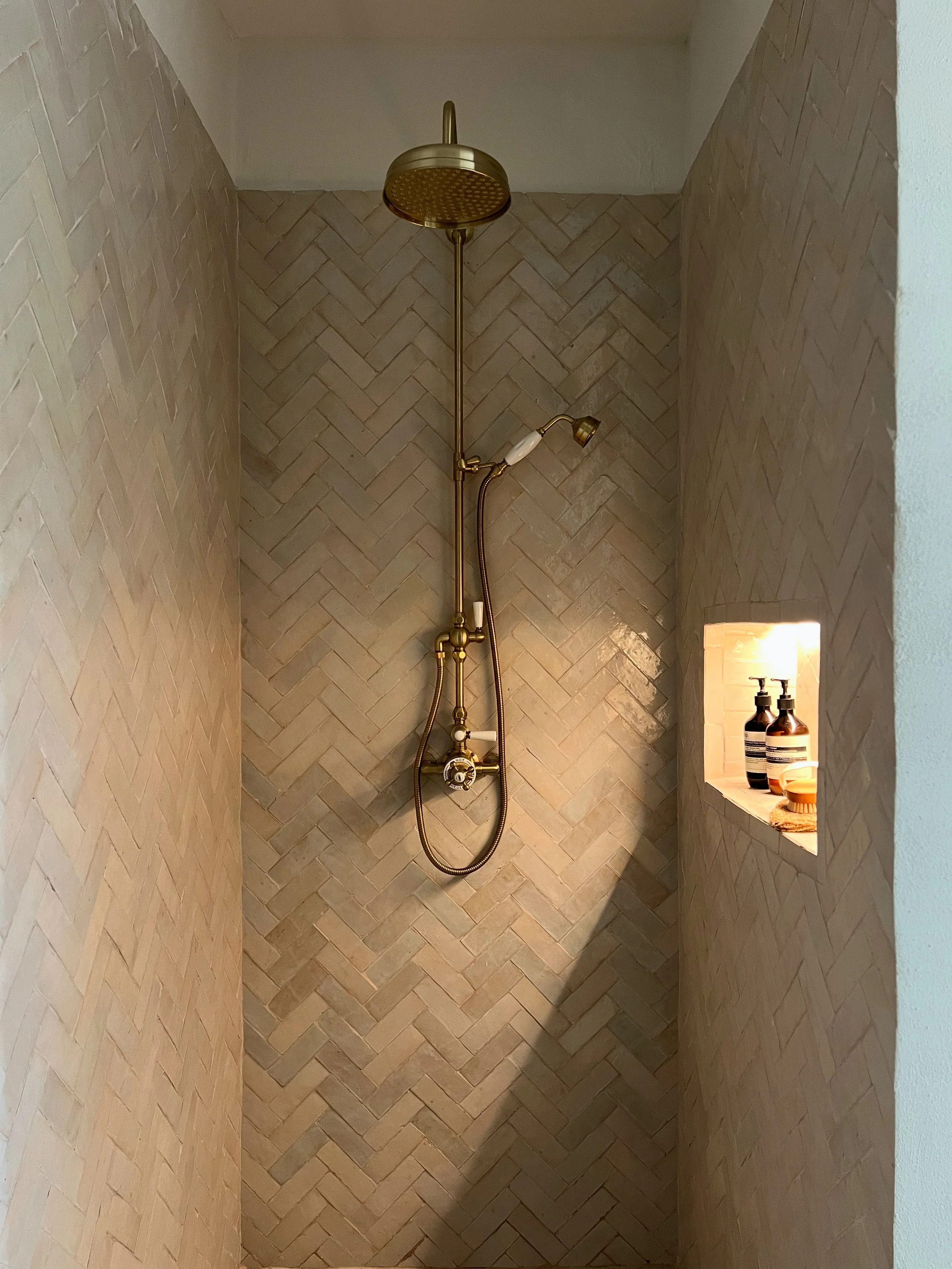 herringbone tile, zellige, bejmat, niche, shower, brass shower, lit niche, Aesop, wellness