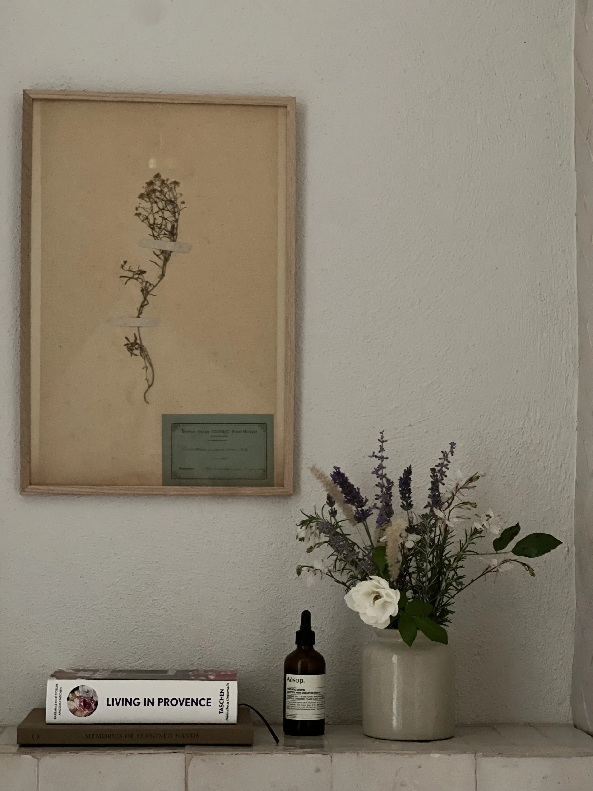 bathroom shelf styling, flowers, Aesop products, antique herbier