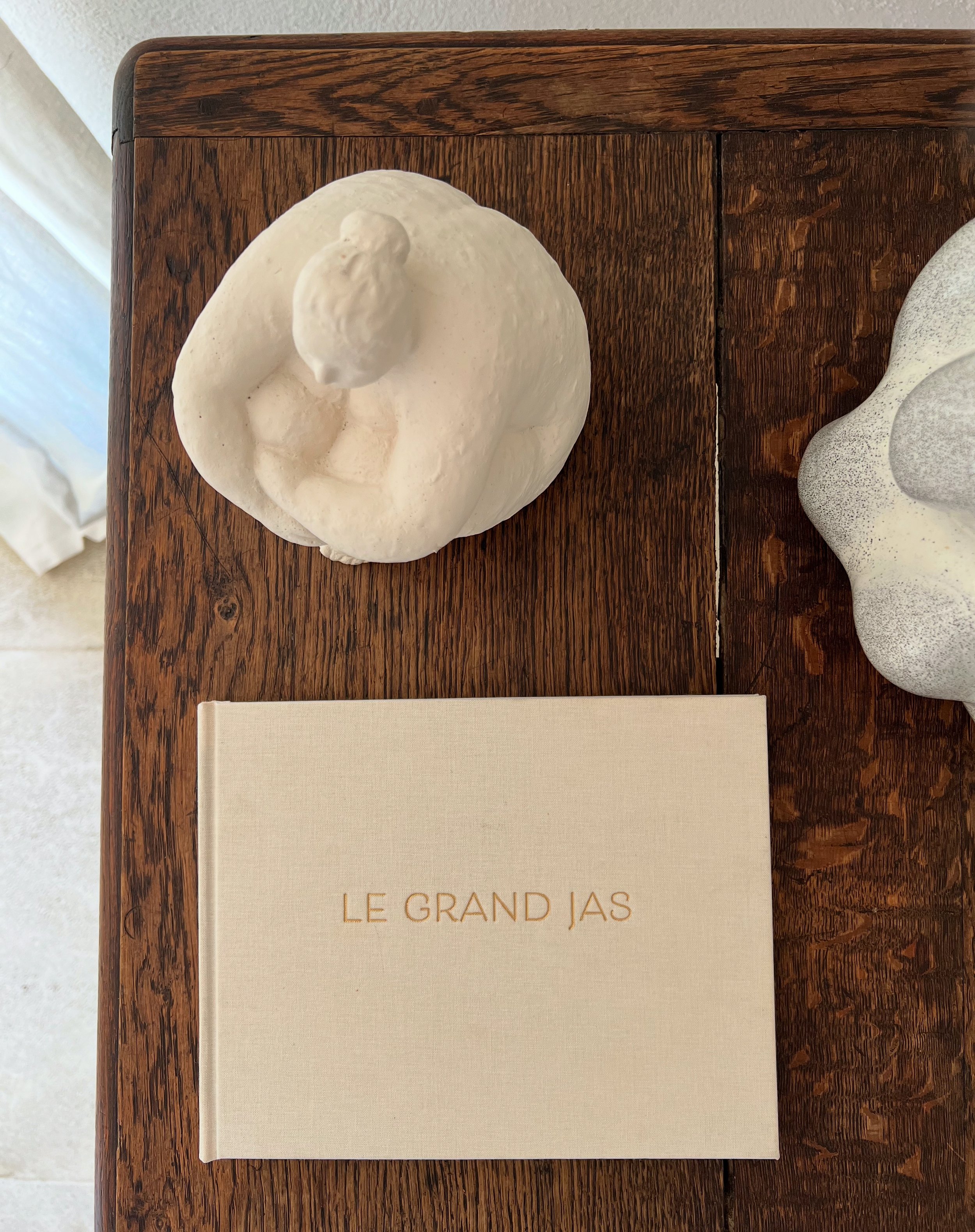 sculpture and book in natural colours