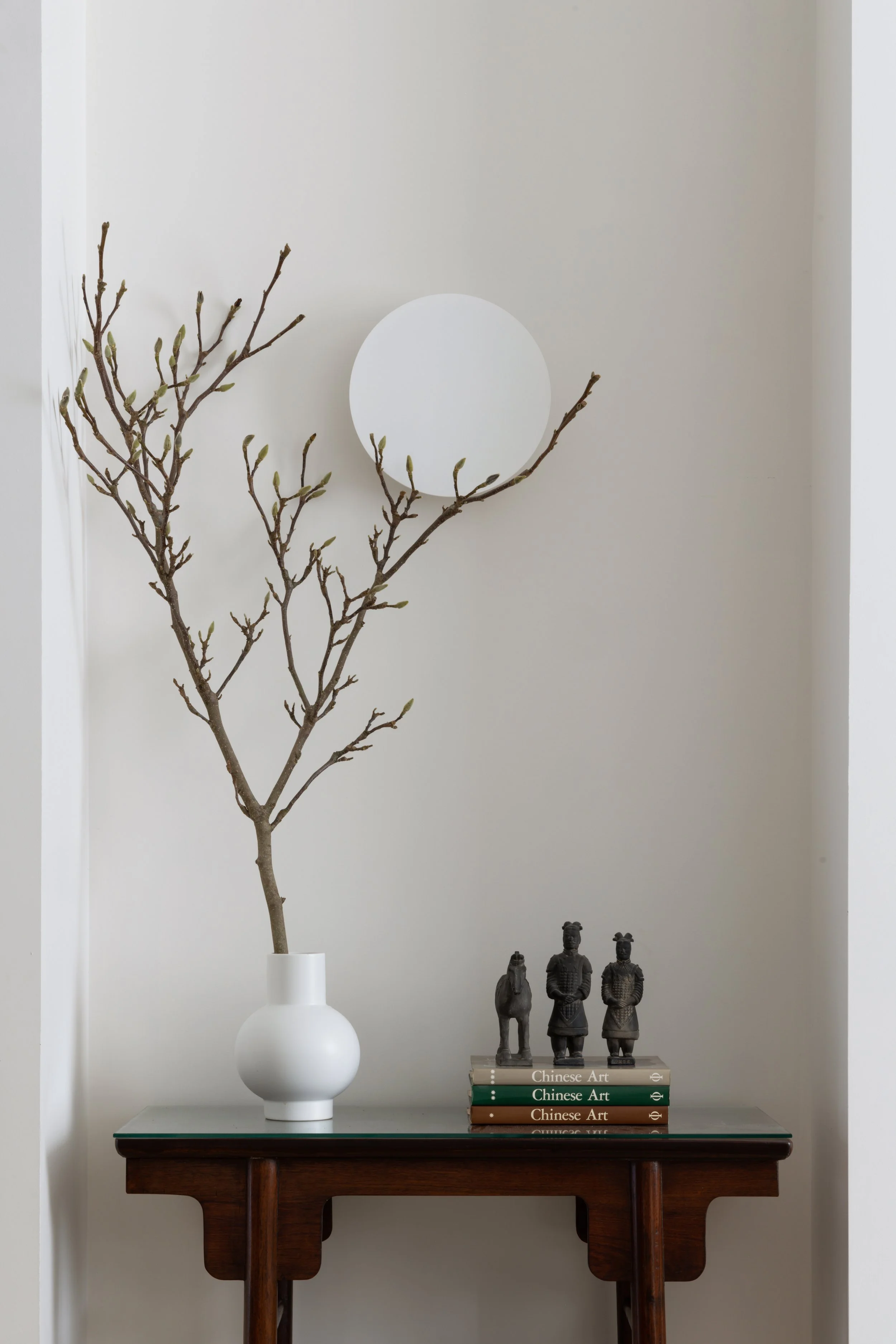A white textured ceramic vase with twisted dried branches, wabi sabi, texture, plants, decoration, styling, interior, decoratrice. Flos light