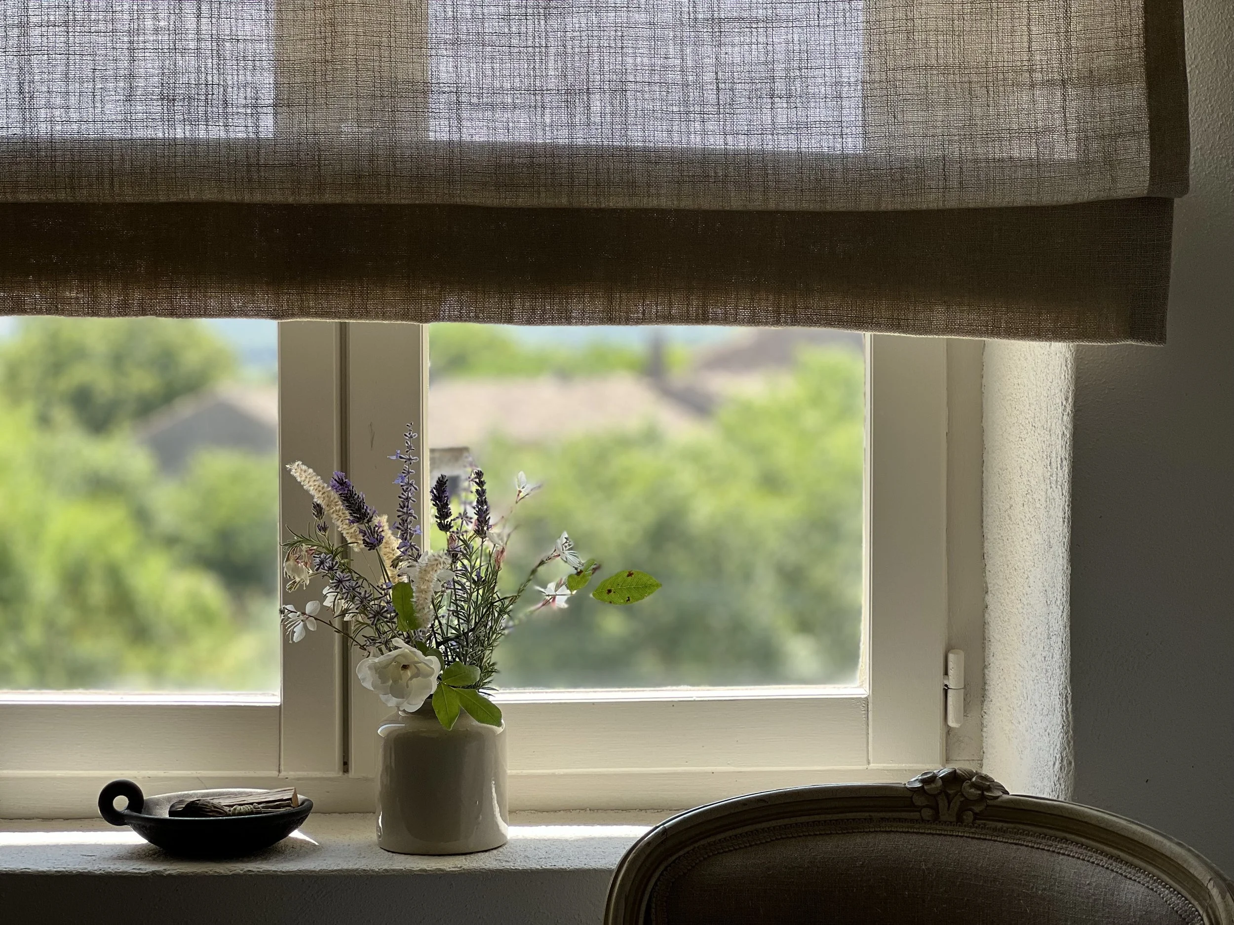 vignette showing a sheer linen blind, flowers, greenery outside, Paolo Santo dish 