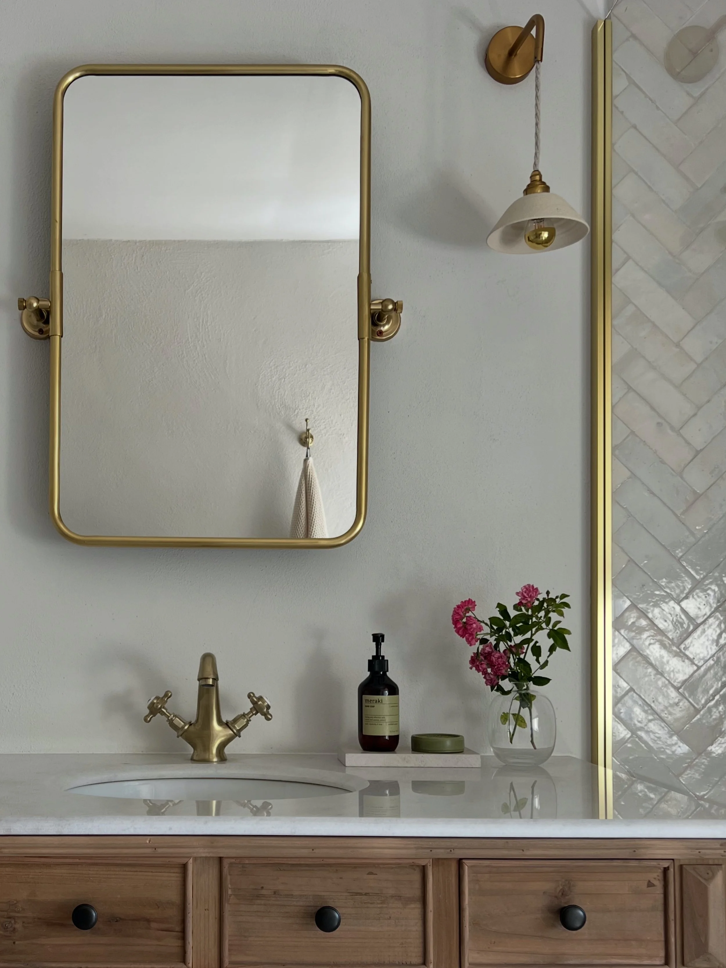 luxury bathroom, calm, sanctuary, brass tap, wood, vanity, flowers, herringbone tile, zellige, bejmat, antique, enamour lights, brass details