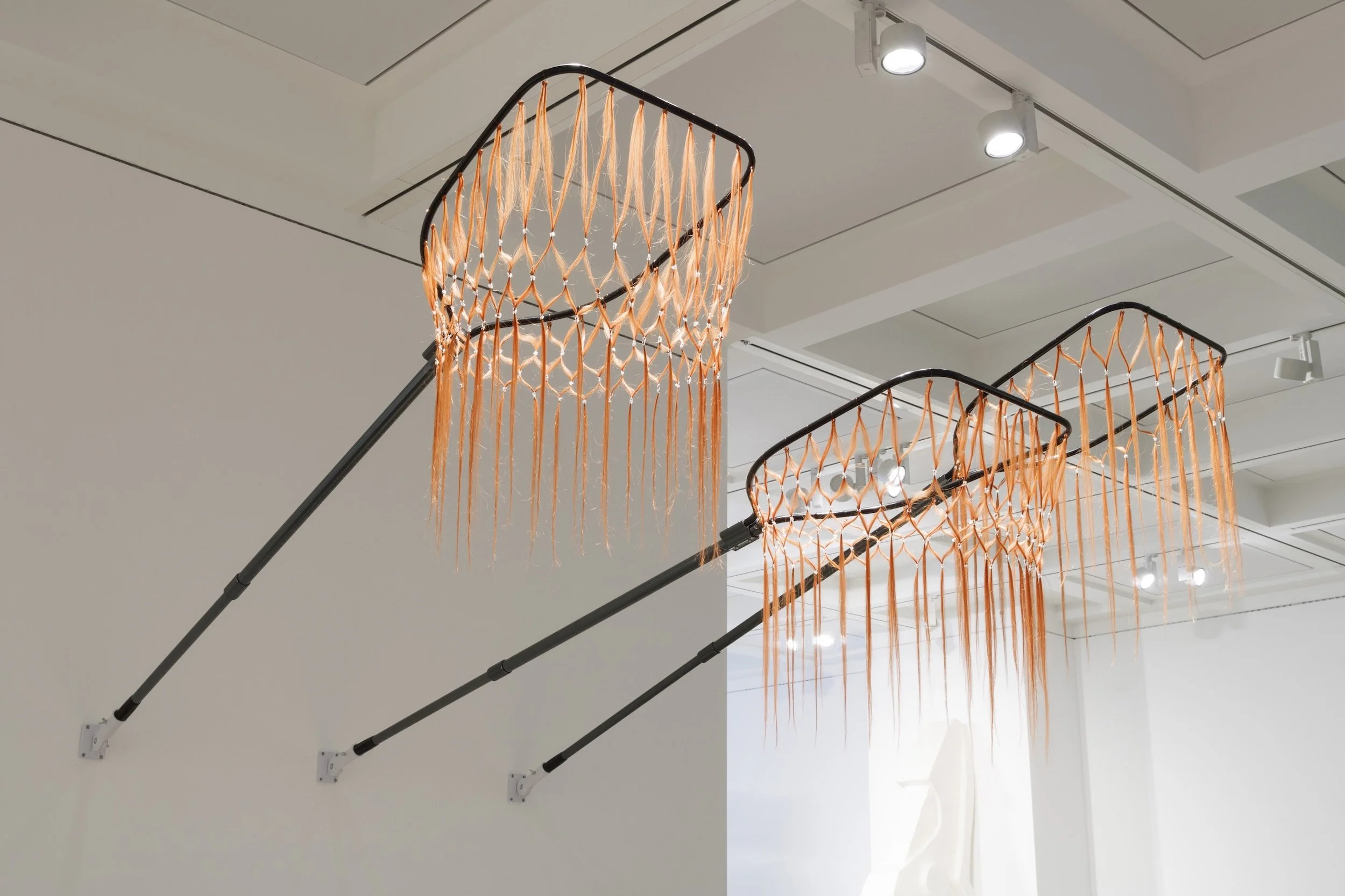 Jule Tabea Martin, you got me all wrong, 2024. Two landing nets for sport fishing with human hair extension nets, installation view