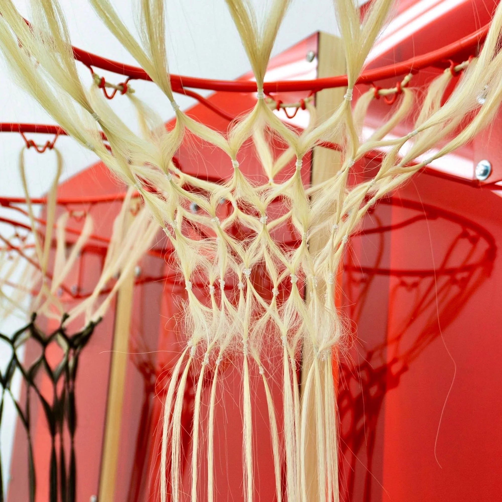 Jule Tabea Martin, Cage Game, detail. Basketball hoop with human hair extension net, wood and metal