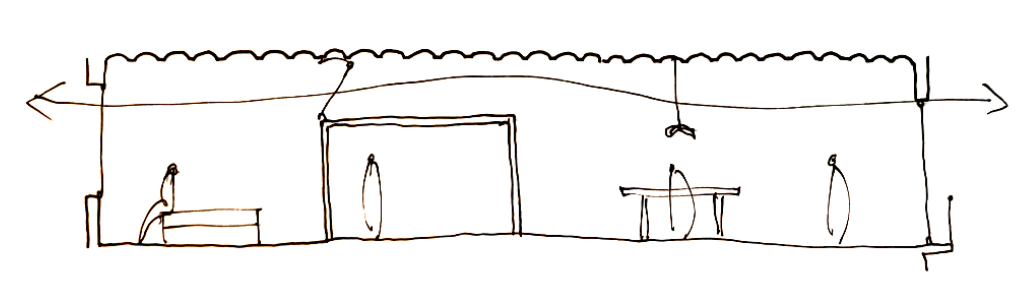 A simple brown line drawing of a building interior with a person sitting at a desk on the left, a door in the middle, and two hanging objects or decorations on the right, with some lines indicating a ceiling and walls.