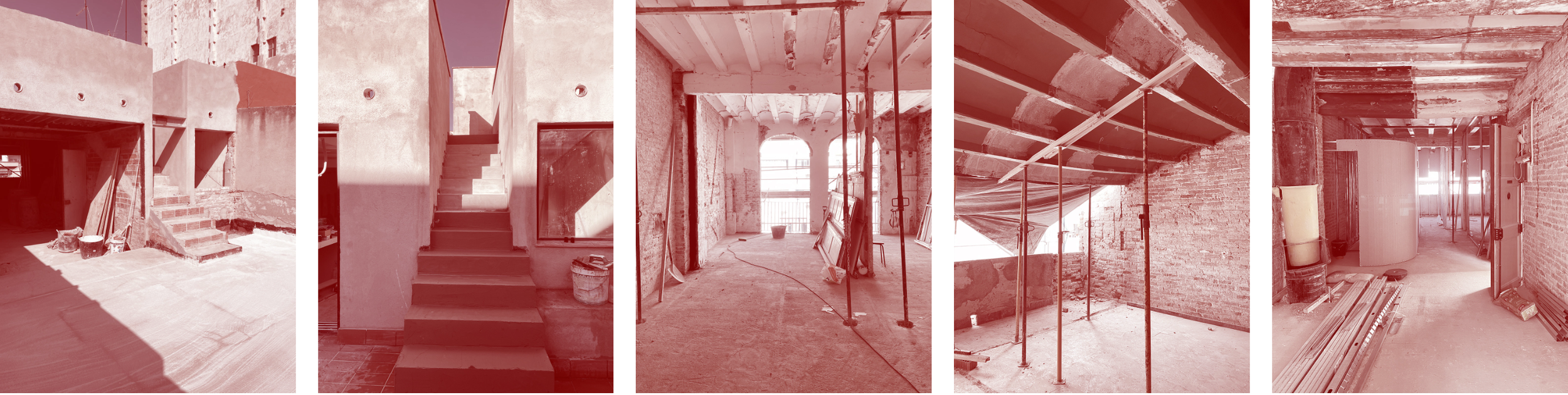 Interior view of a building under construction with exposed brickwork, scaffolding, and construction tools and materials.