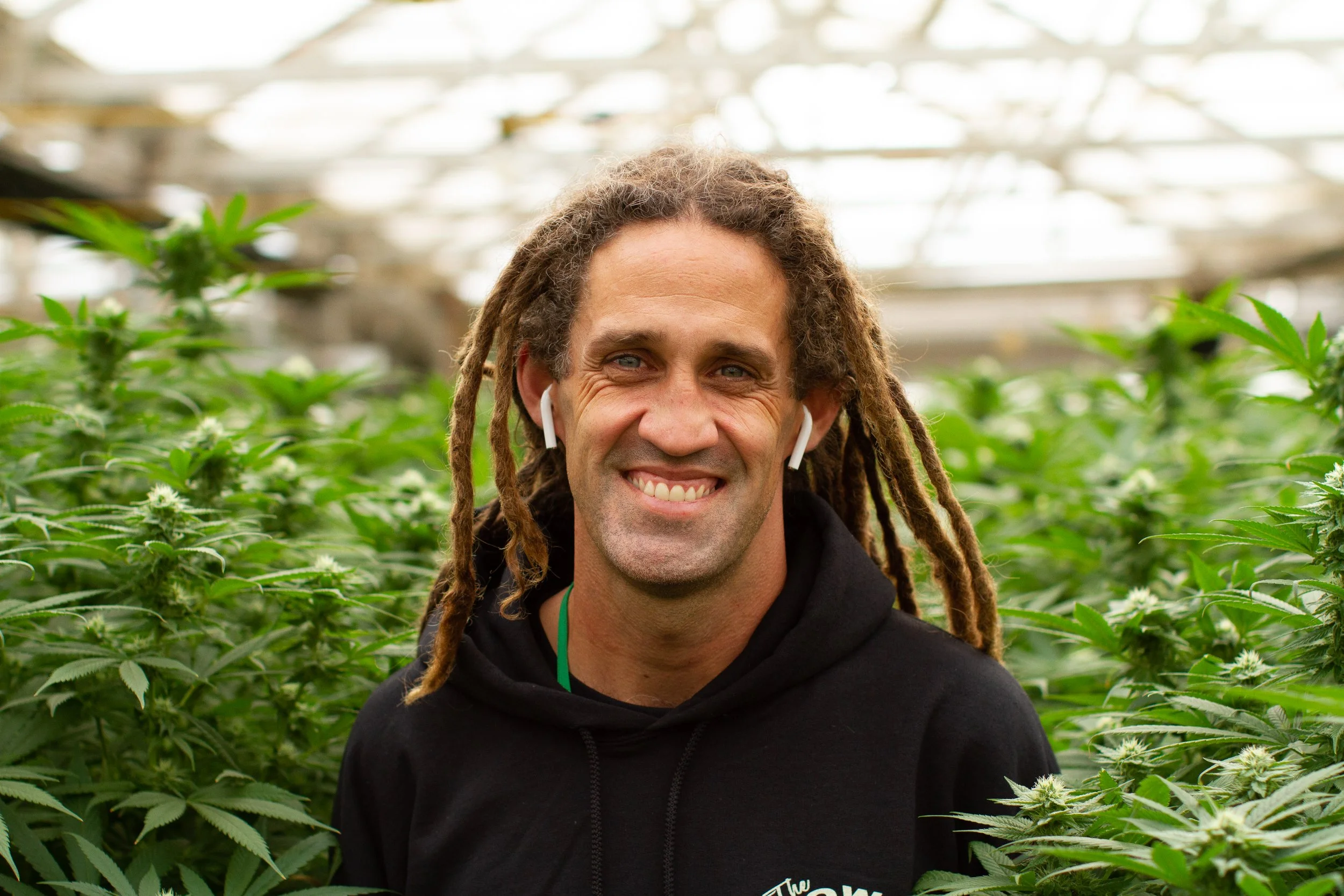 Cannabis grower portrait in greenhouse, California farm