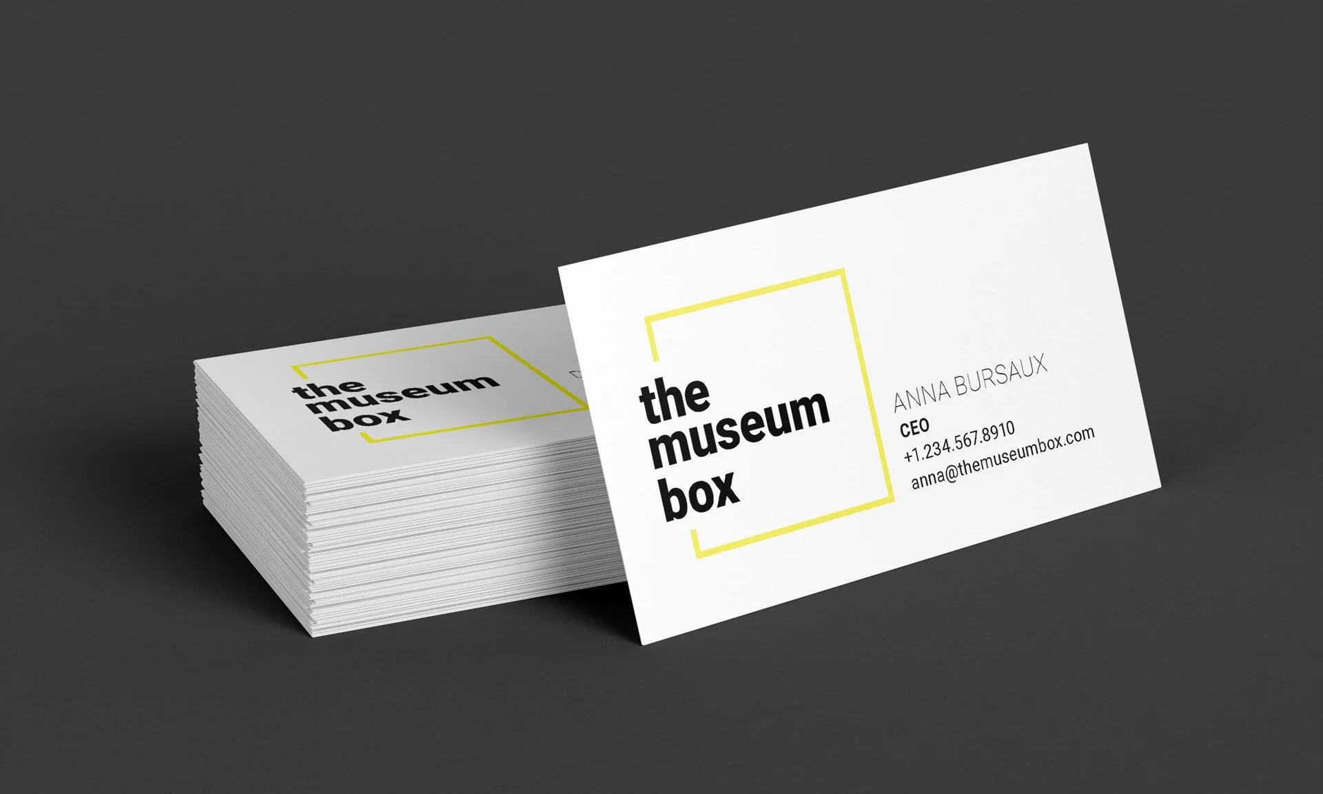 A mockup of a business card featuring a "The Museum Box" logo and employee contact information.