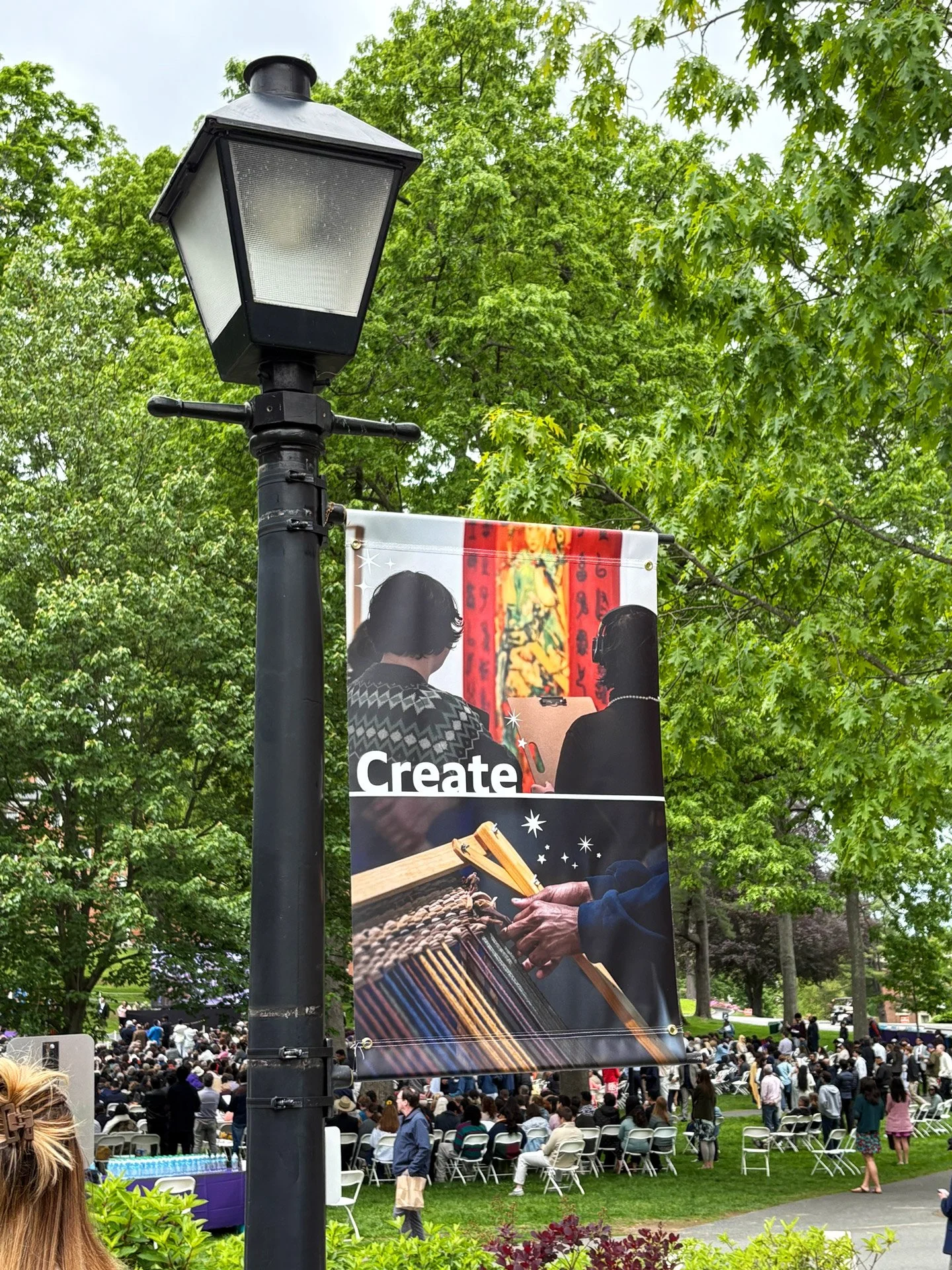 A photo of a lamp post banner outside the Mead Art Museum.