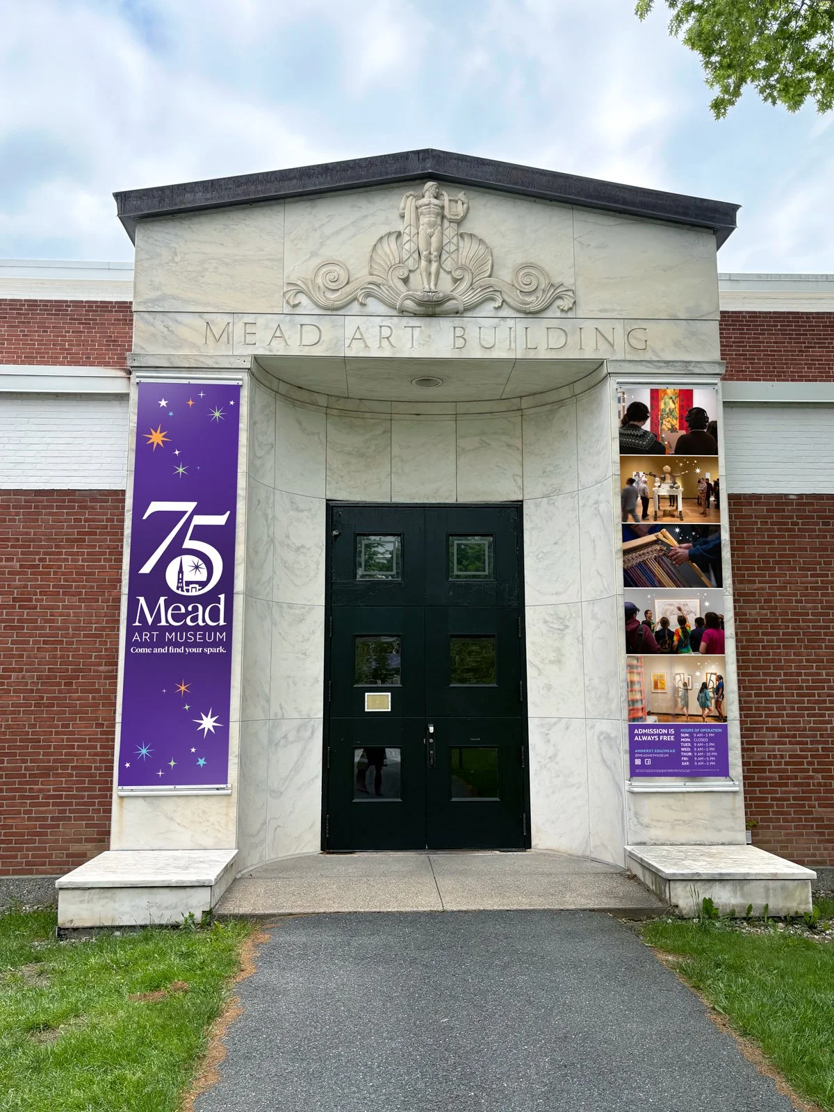 A photo of the entrance to the Mead Art Museum, featuring two decorative banners on either side of the door.
