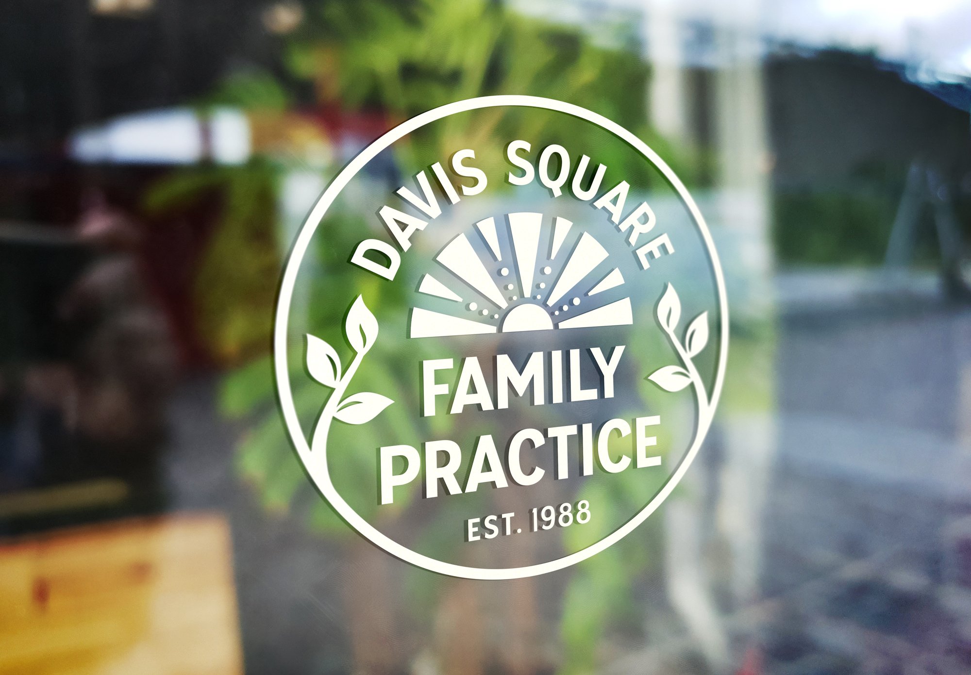 A mockup of the Davis Square Family Practice logo as a vinyl window cling.