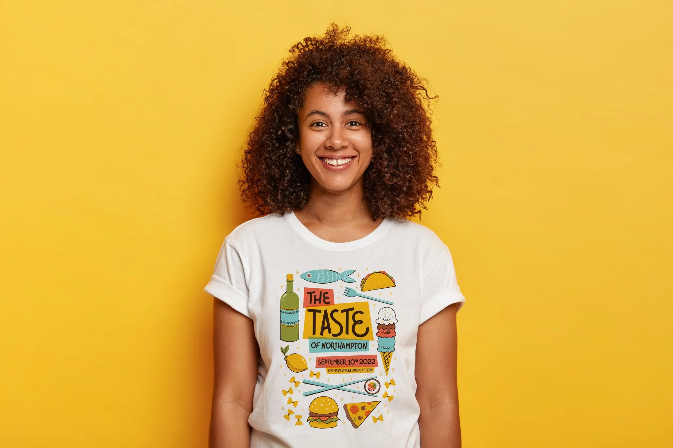 A mockup of a t-shirt featuring the Taste of Northampton logo and a variety of foods.