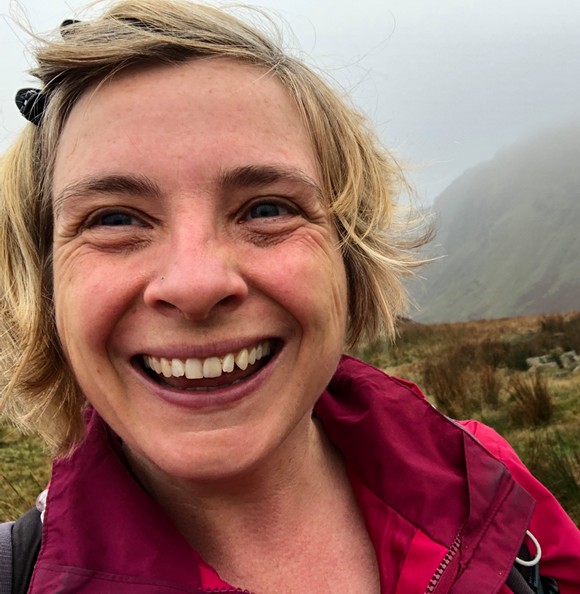 Close-up of Bob, outdoors in a foggy mountainous landscape.
