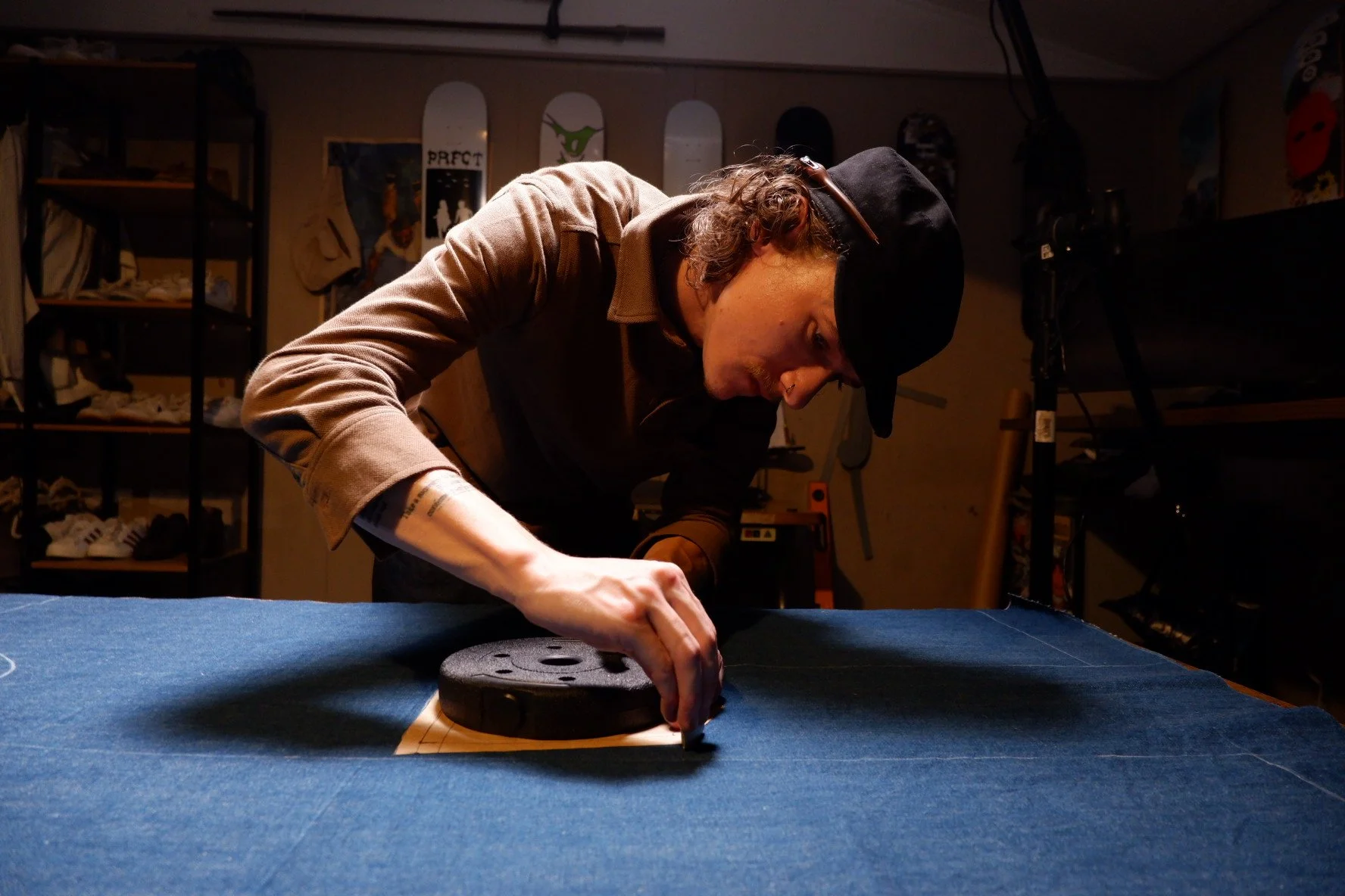 A person measuring fabric in a workshop.