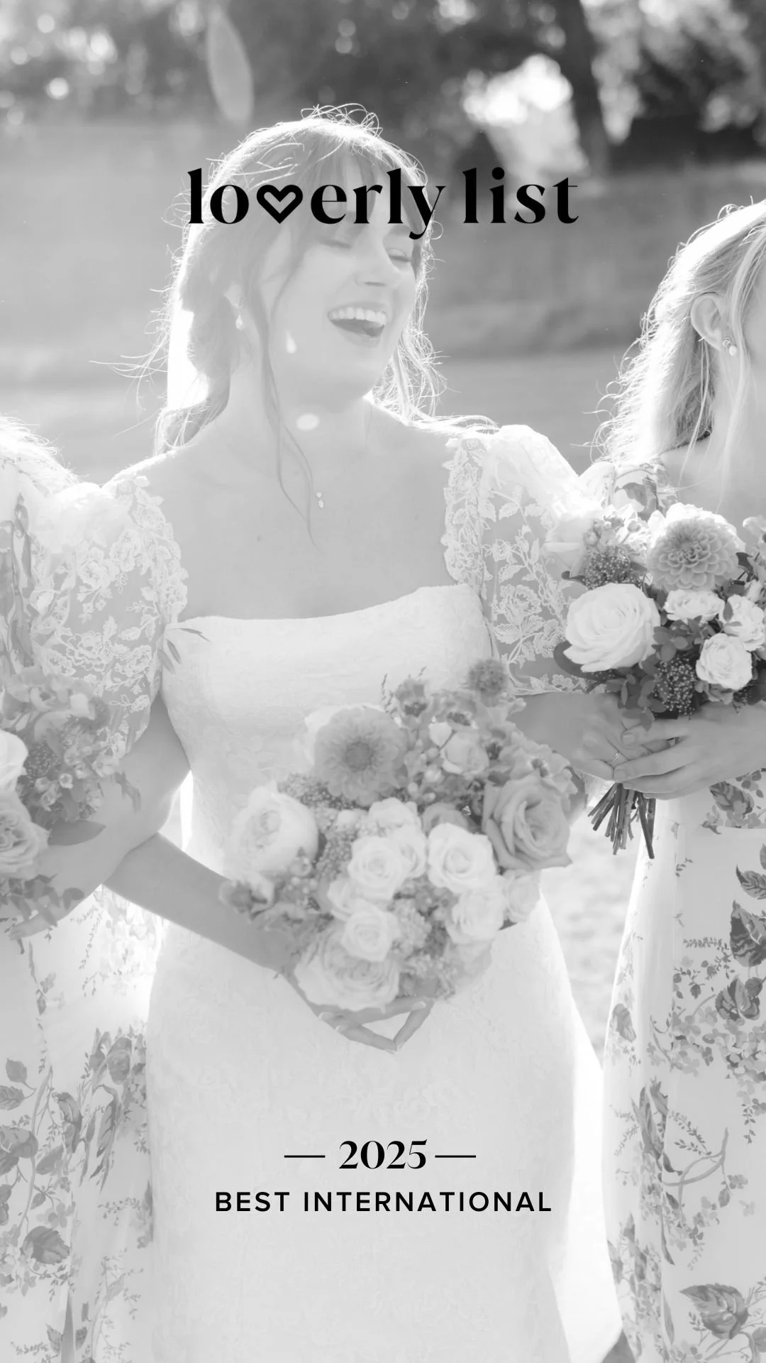 Black and white photo of a woman in a wedding dress holding a bouquet of flowers, smiling. Text on the image reads "Loverly List 2025 Best International."