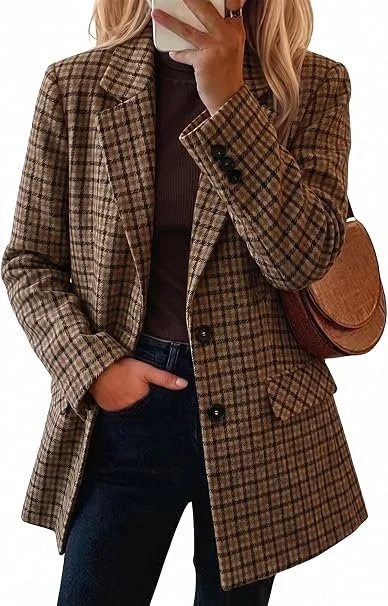 A person taking a mirror selfie wearing a brown plaid blazer, dark jeans, and a black top, with a brown shoulder bag.
