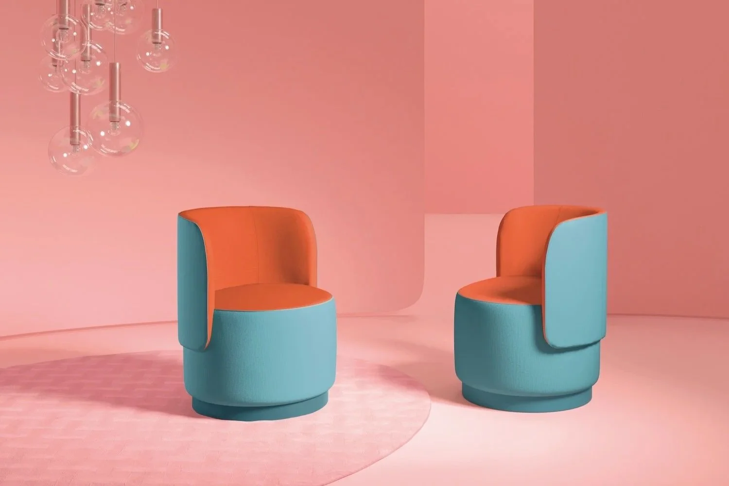 Two colorful modern chairs, one orange and blue, are placed on a pink background with a circular pink rug beneath them. A cluster of transparent pendant lights hangs from the ceiling on the left side of the image.