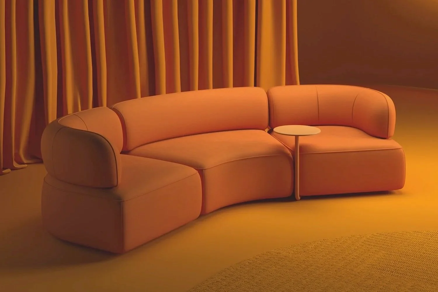 Modern coral-colored sectional sofa with a small round side table in a warmly lit room with golden curtains.