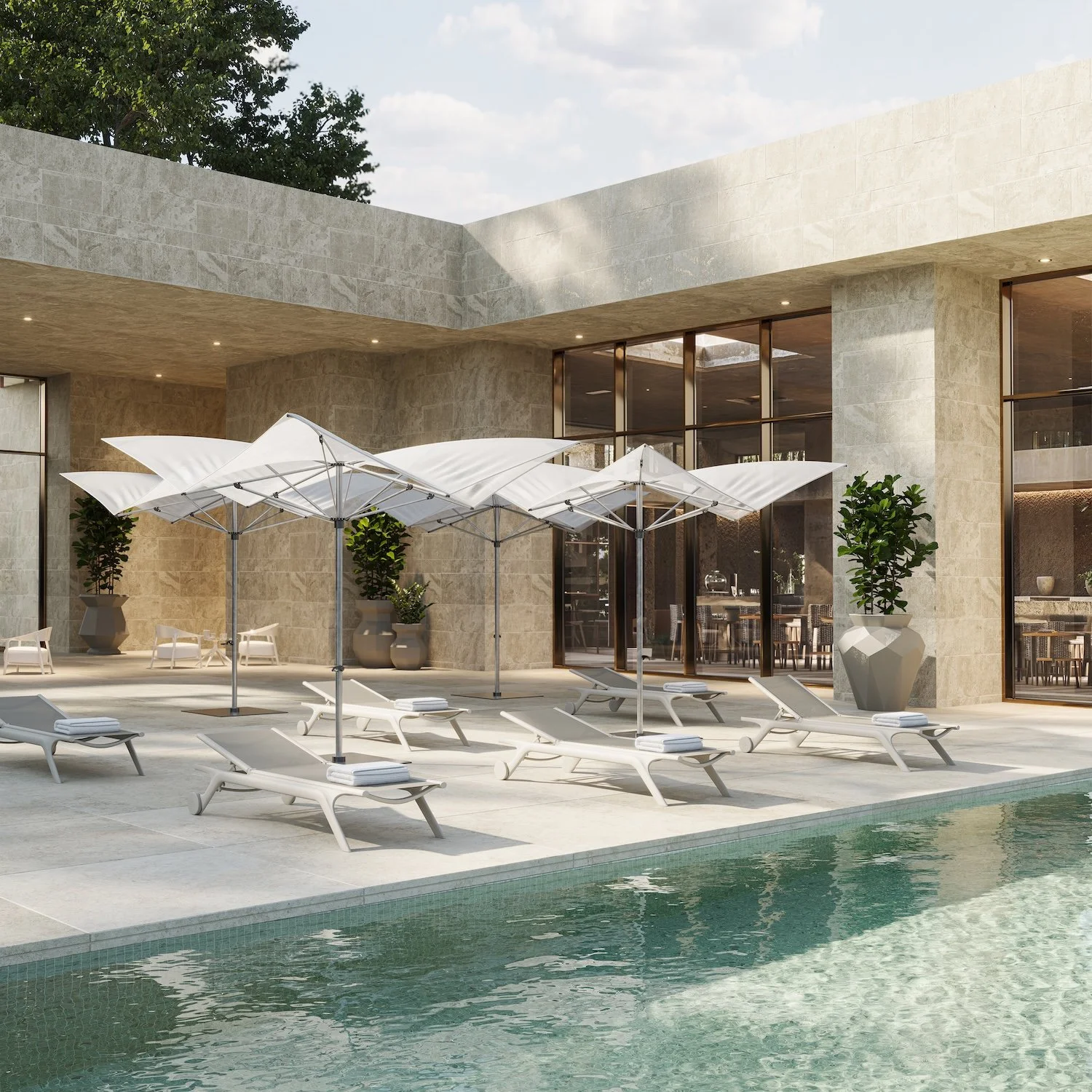 Luxury poolside area with lounge chairs, umbrellas, and potted plants in front of a modern building with large glass windows.
