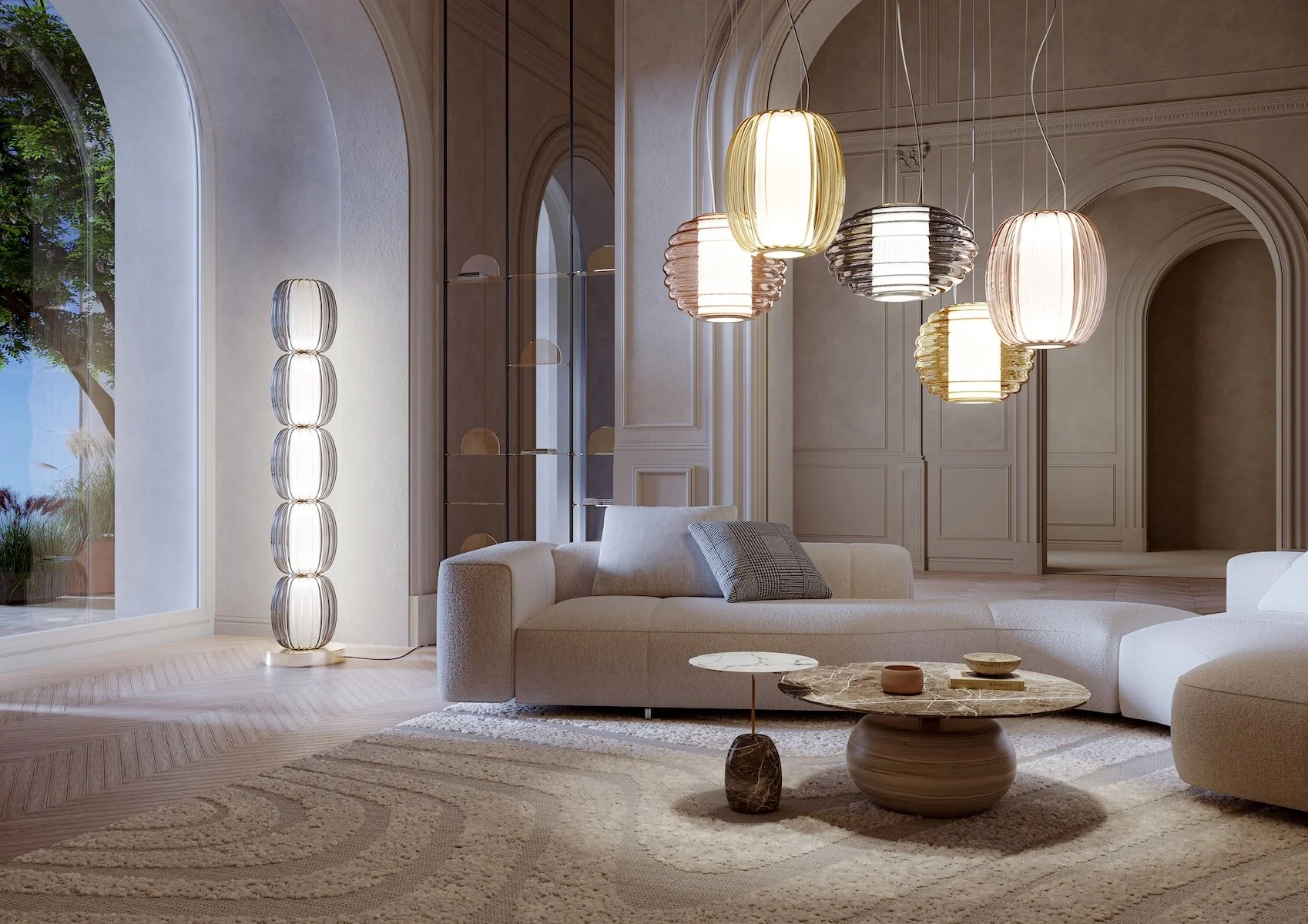 A modern living room with a large L-shaped sofa, a marble coffee table, multiple pendant lights hanging from the ceiling, a floor lamp made of stacked glass orbs, a textured rug, and tall arched windows showing an outdoor view with trees.
