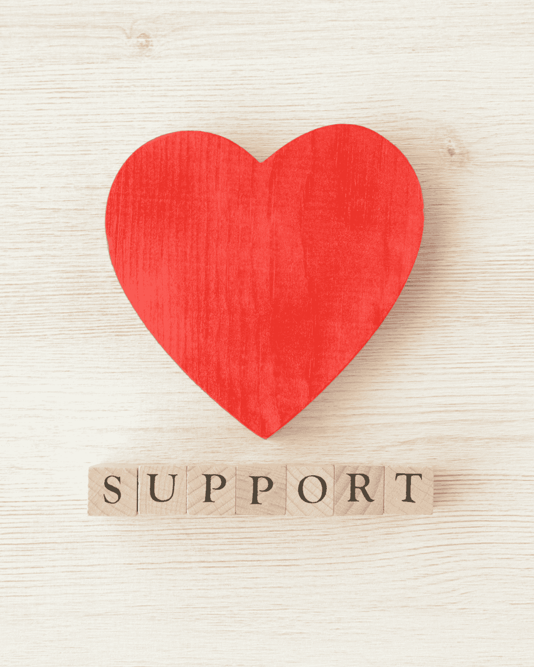 wooden heart with wooden letters spelling out support