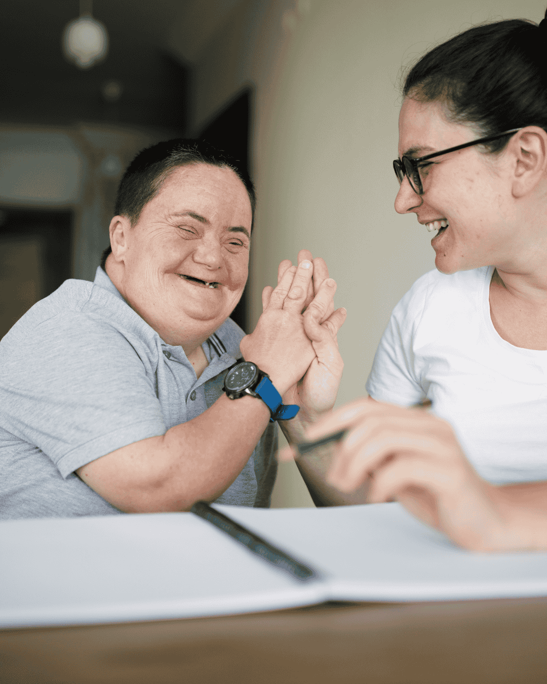 a man with down syndrome shares a happy moment with his carer
