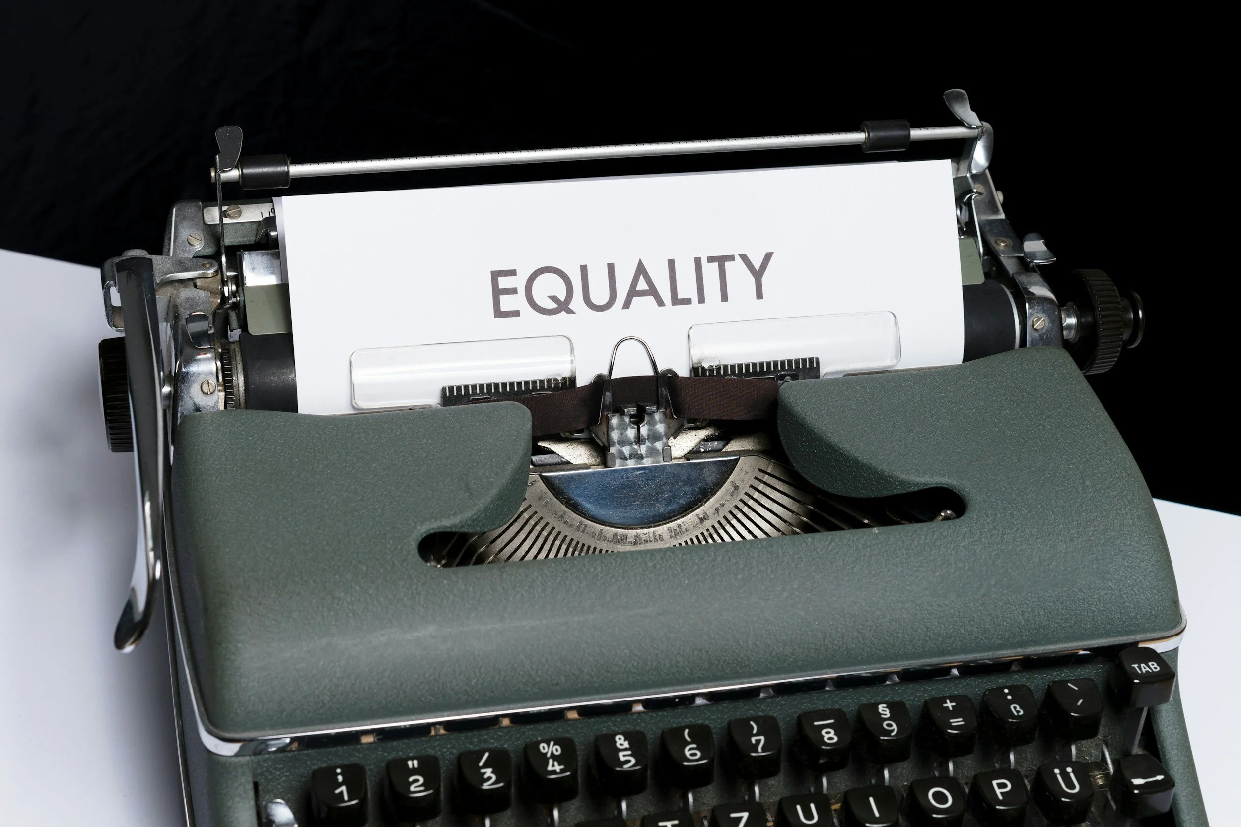 traditional typewriter with paper showing words equality