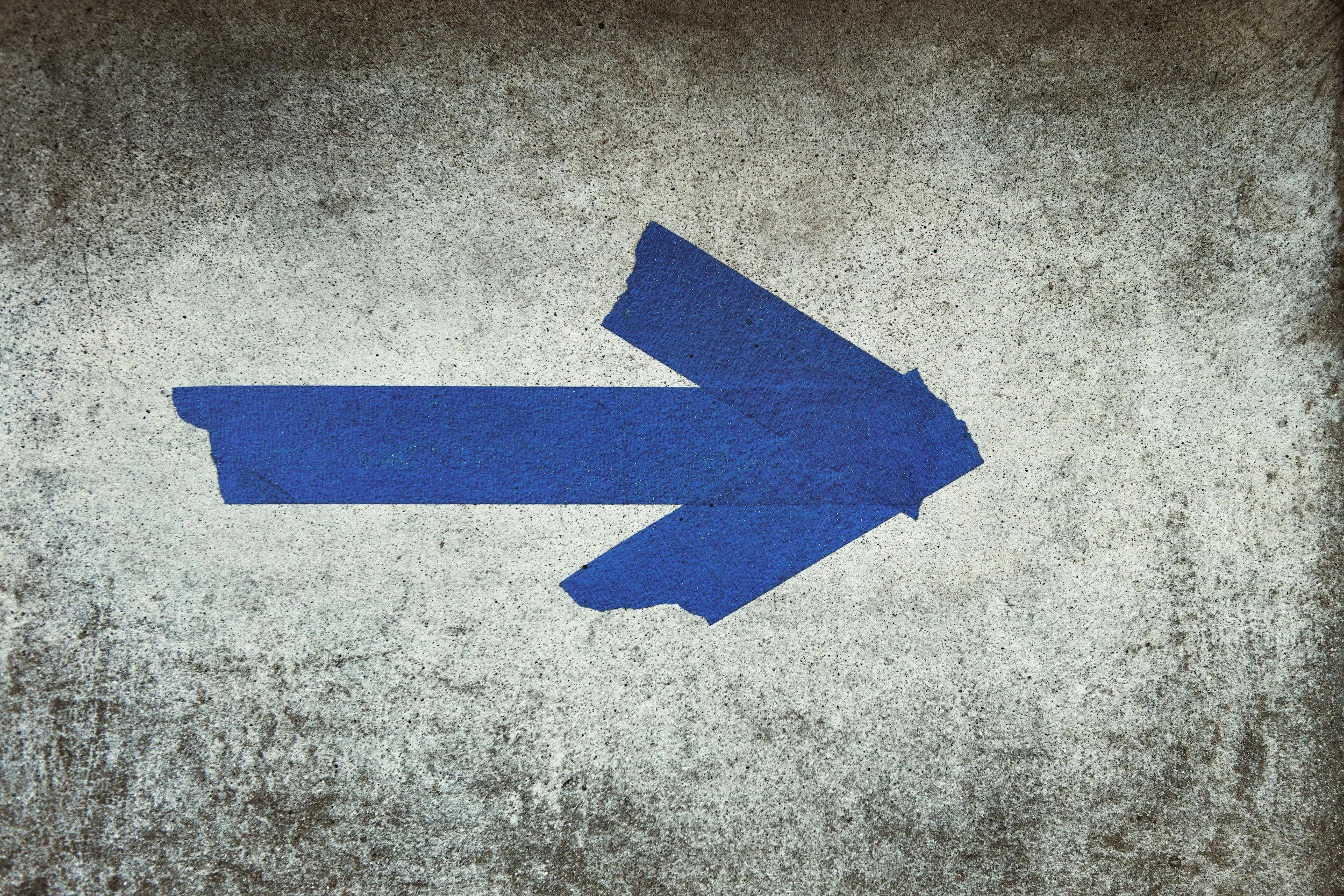 blue paper arrow searching for directions concept