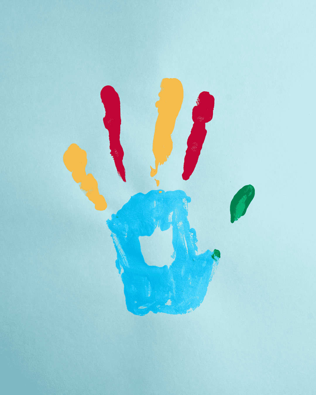 a colourful hand paint print on a light blue background autism concept
