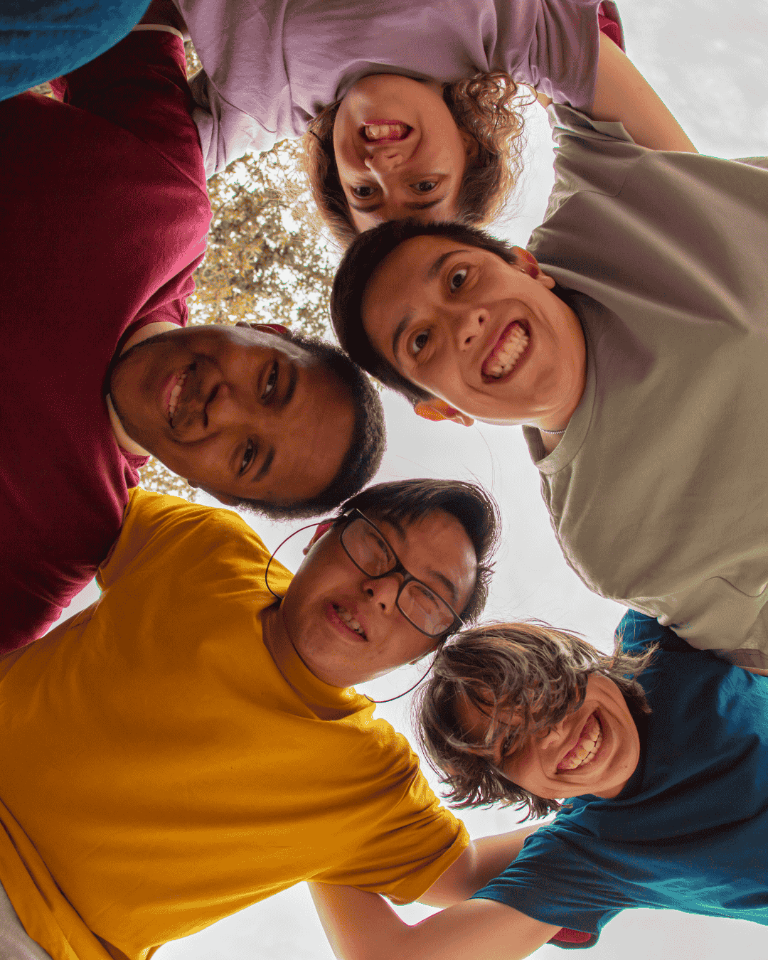 a happy group of children with learning disabilities smile at the camera