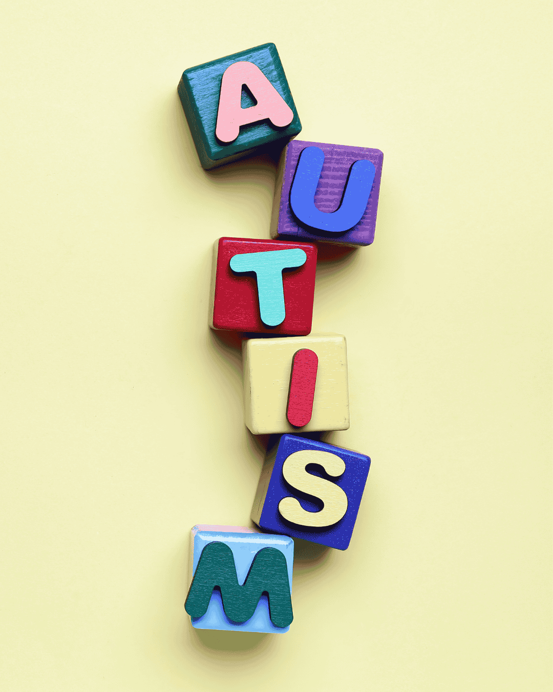 colourful letter blocks vertically placed to read autism