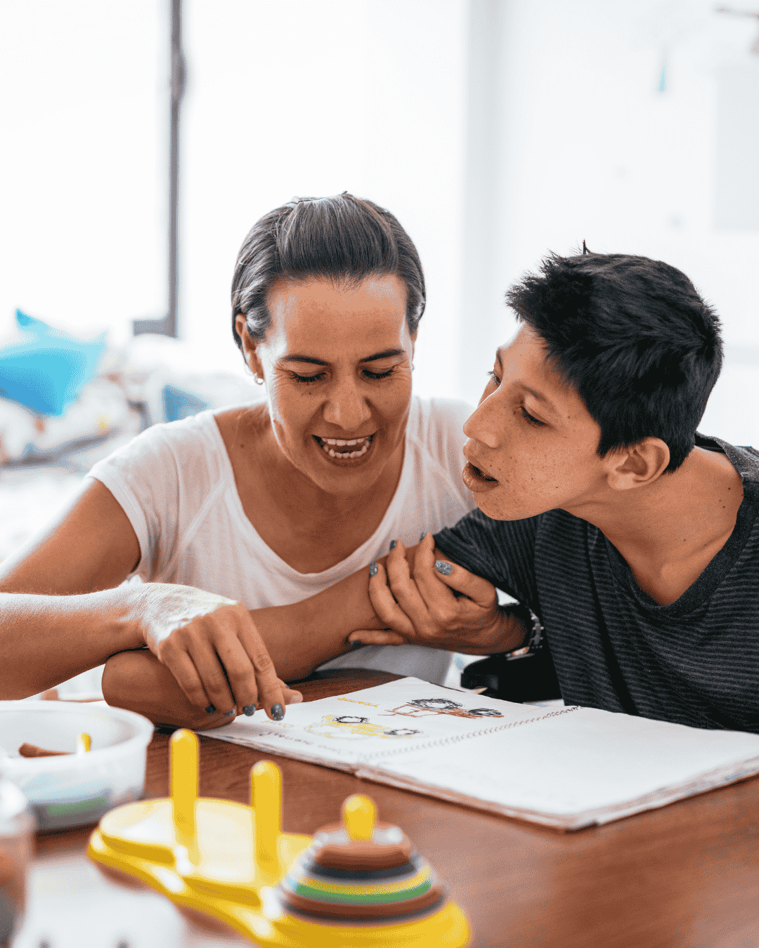 a woman does a reading activity with her non verbal son
