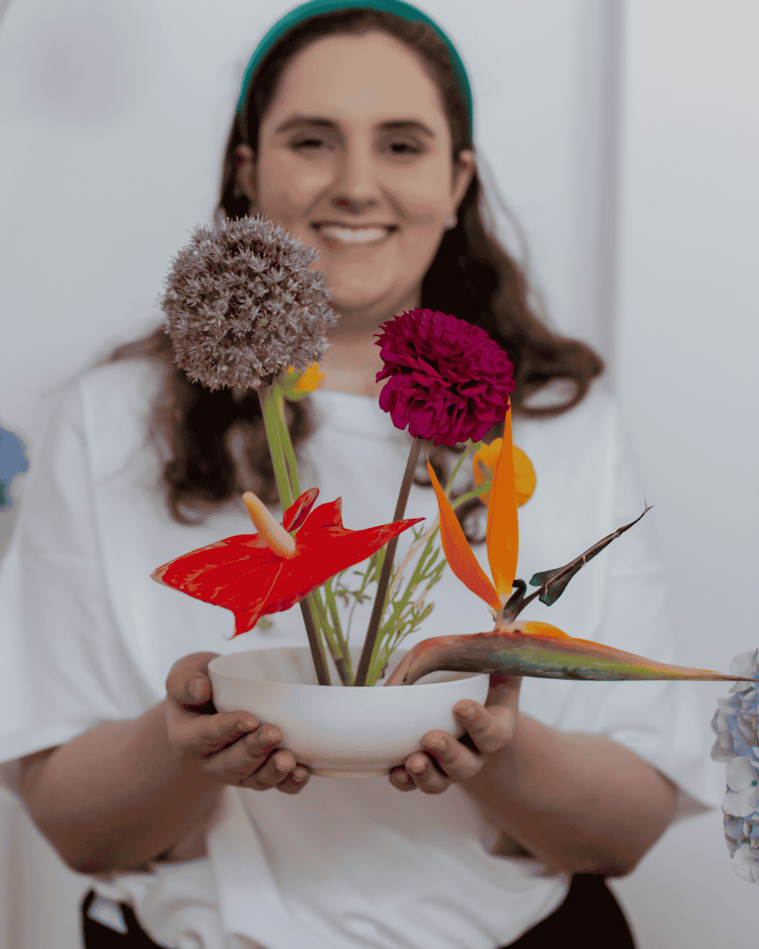 woman holds an arrangement of flowers