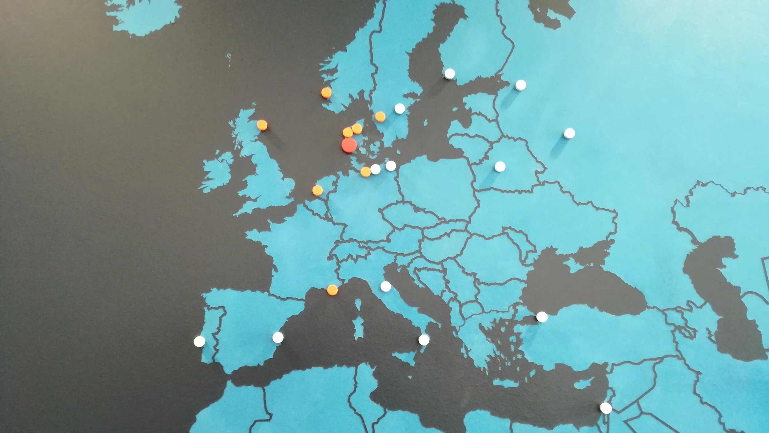 Map of Europe with various colored pins marking locations in different countries.