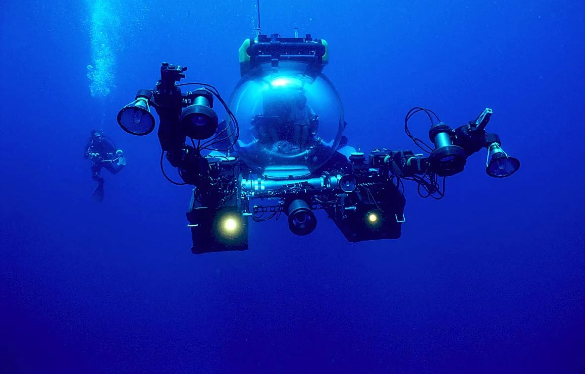Underwater drone with cameras and lights, and scuba diver in background