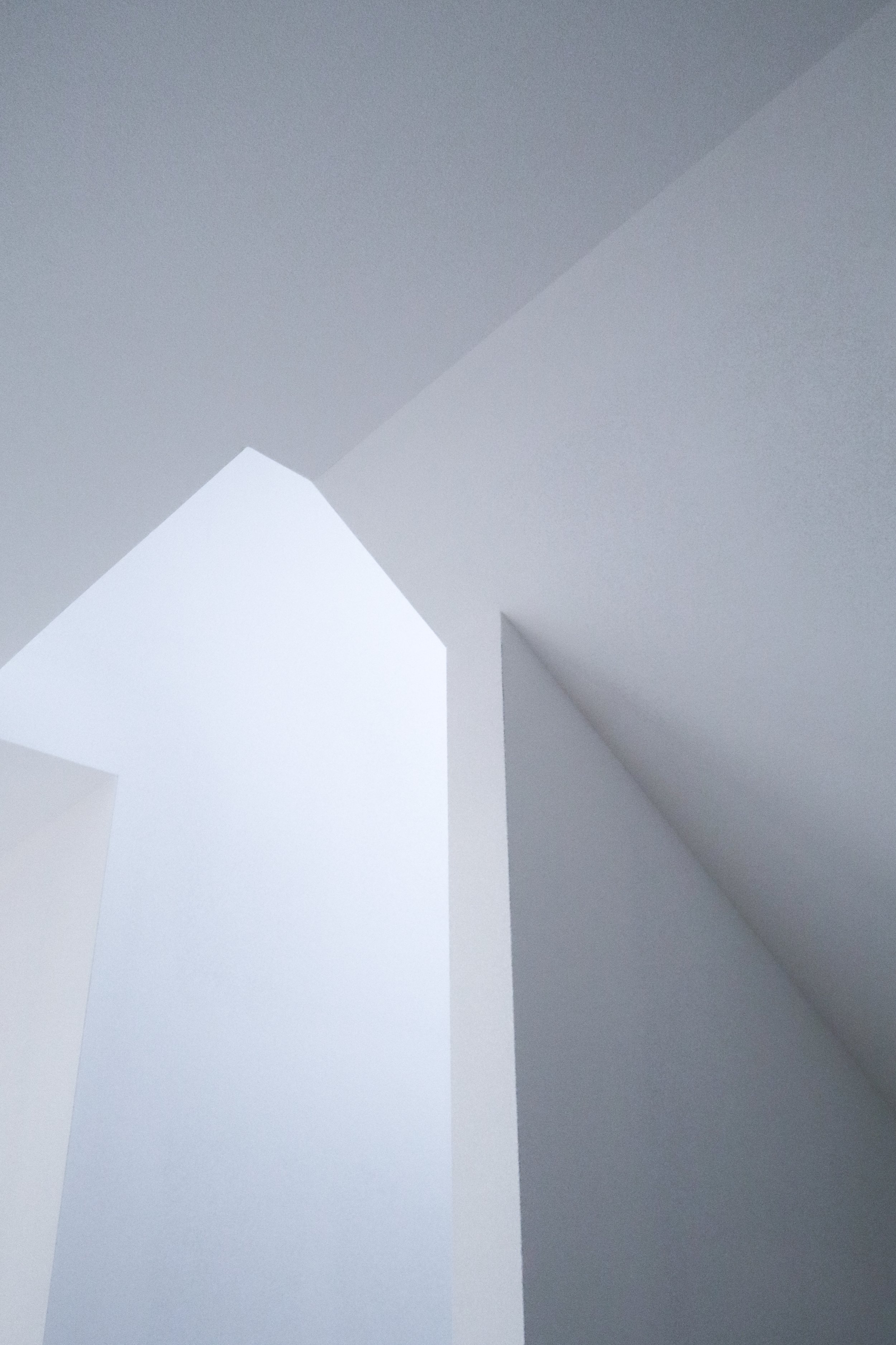 Minimalist interior ceiling with geometric shapes and clean white walls.