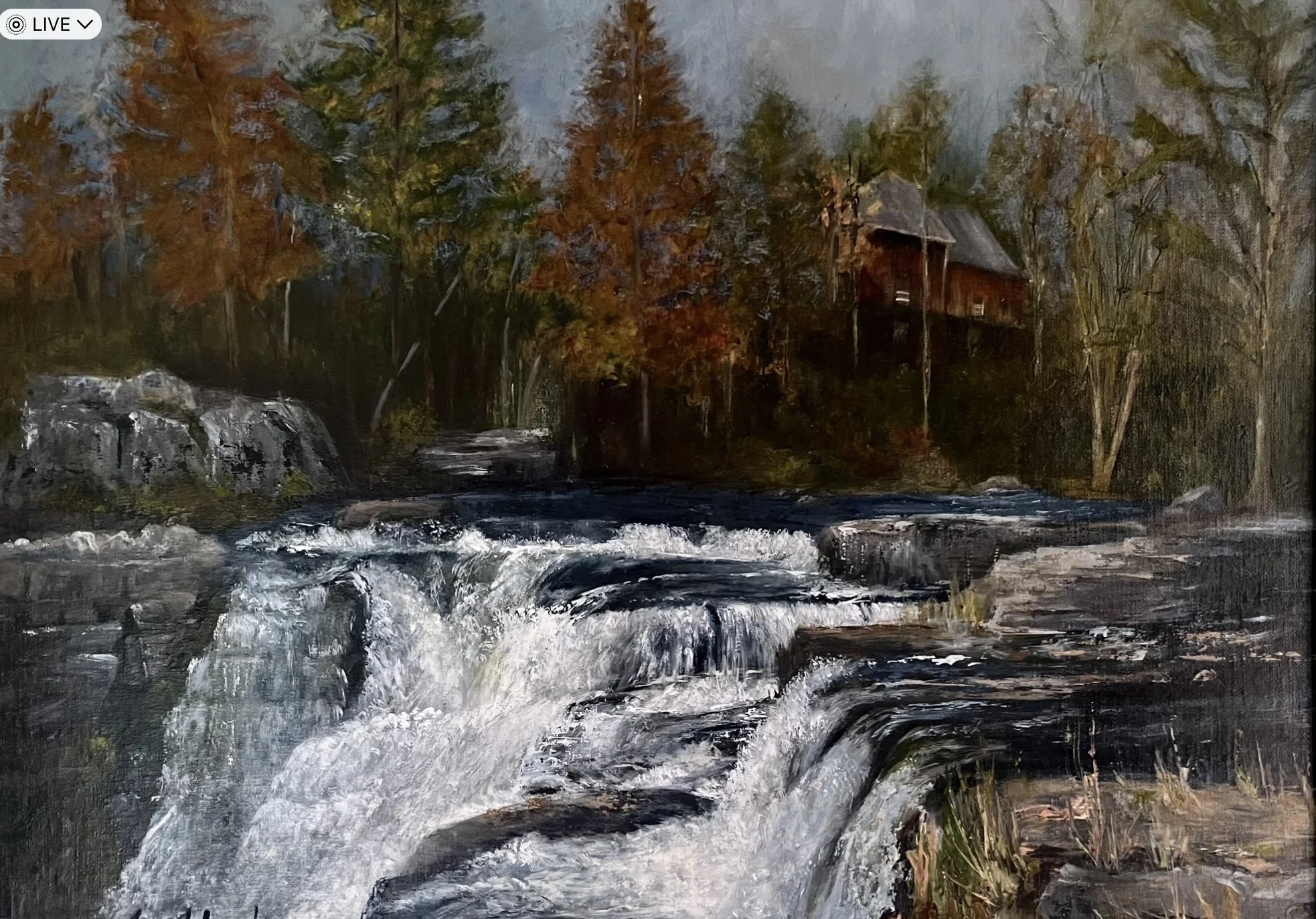 A painting of a river flowing over rocks with autumn trees and a wooden building in the background.