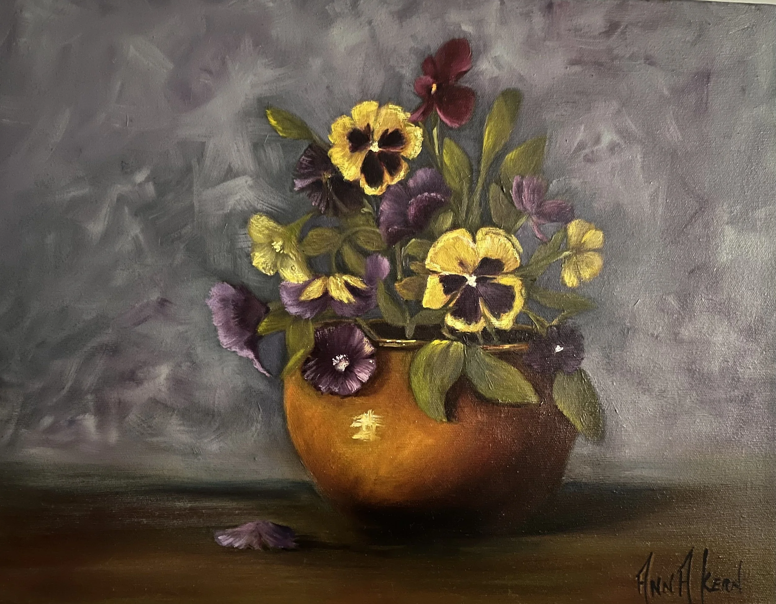 A still life painting of a brown vase filled with purple and yellow pansy flowers, with some fallen petals, against a gray background.