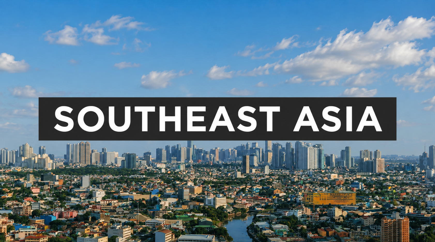 Cityscape of Southeast Asia showing tall buildings, a river, and residential areas under a partly cloudy sky.